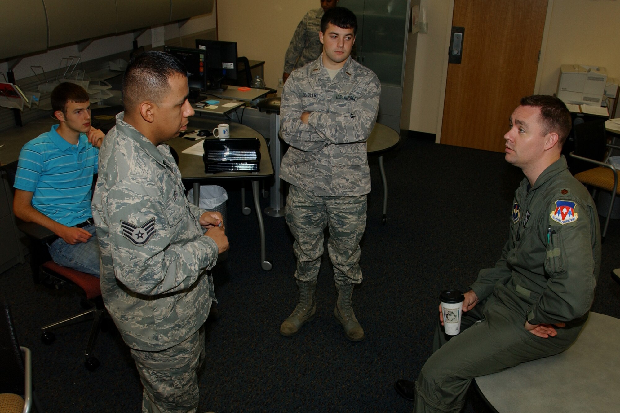 Maj. Matt Eckles (right), wing deployment center chief, talks with some of his staff in the wing deployment center. The WDC recently stood up to streamline the deployment process for Vance Airmen. (U.S. Air Force photo by Staff Sgt. Brian Hill)