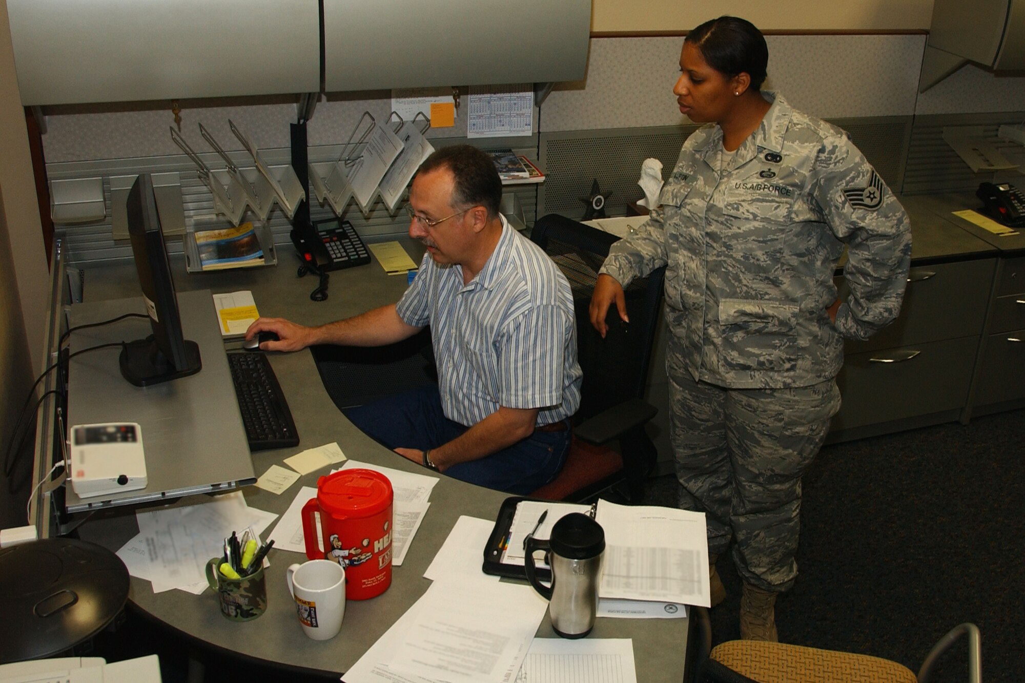 Calvin Miller, installation deployment officer, and Staff Sgt. Alexis Martin, a logistics planner assigned to the installation deployment readiness center, work inside the wing deployment center alongside the deployment managers and the personnel readiness unit -- streamlining the deployment process for Vance Airmen. (U.S. Air Force photo by Staff Sgt. Brian Hill)