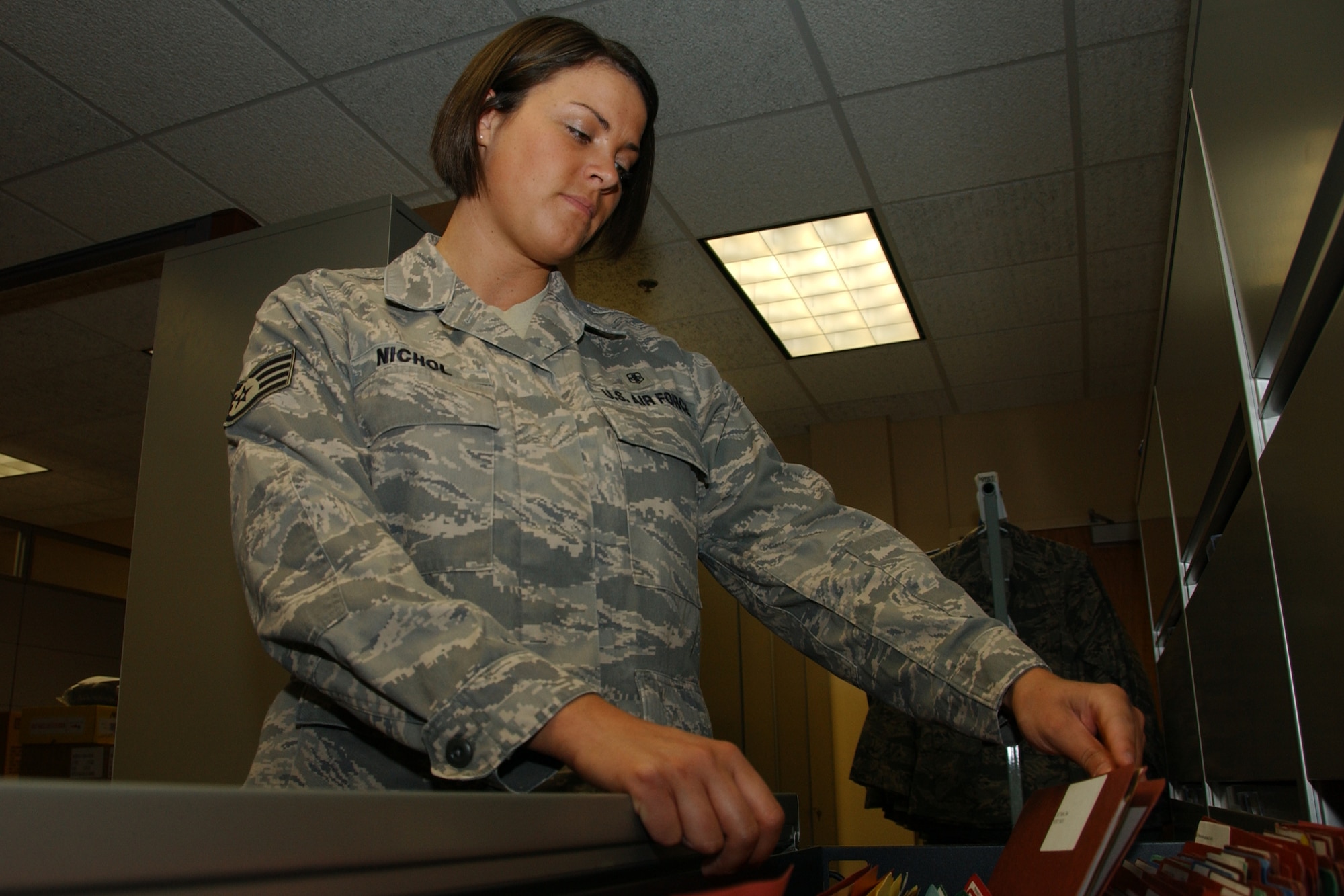 Staff Sgt. Amy Nichol, wing deployment center deployment manager, assists in maintaining more than 120 mobility folders. She formerly was a unit deployment manager for the 71st Medical Group. (U.S. Air Force photo by Staff Sgt. Brian Hill)