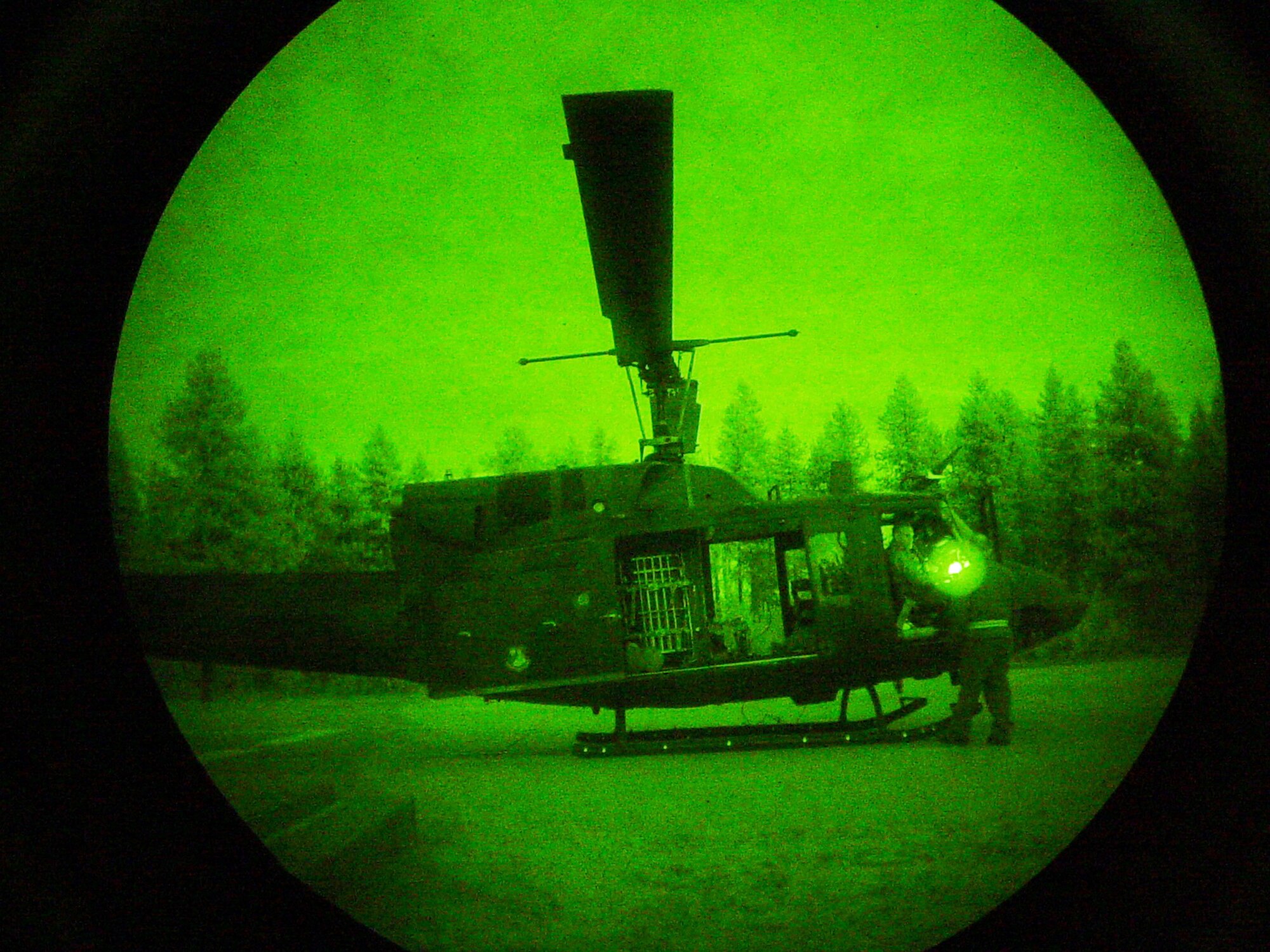 A UH-1N Huey is seen through pair of night-vision goggles June 26 in Washington. Airmen of the 36th Rescue Flight from Fairchild Air Force Base, Wash., rescued a hiker from Fort Lewis, Wash., who tumbled more than 1,000 feet down a mountain just west of Wenatchee, Wash. (U.S. Air Force photo/Staff Sgt. Jacob Bragg) 