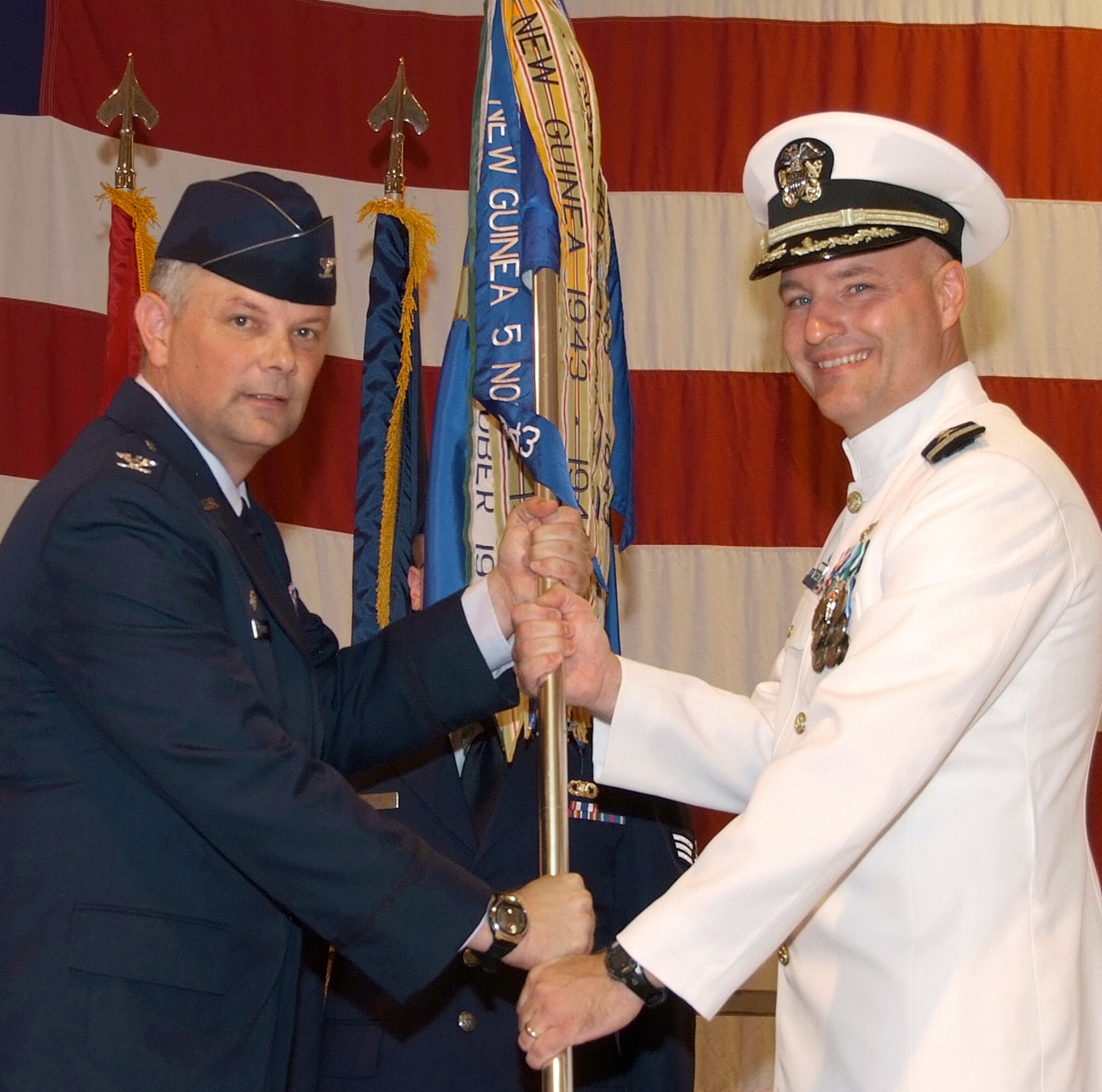 Navy Cmdr. Todd Bahlau, right, accepts command of the 33rd Flying Training Squadron from Col. Glen VanHerck, 71st Operations Group commander, during a ceremony held June 26 in Hangar 170. Commander Bahlau was a T-6 instructor pilot and operations officer for the 33rd FTS. He replaced Lt. Col. Robert Capozzella who was reassigned to Maxwell AFB, Ala., to attend Air War College. (U.S. Air Force photo/ Terry Wasson)