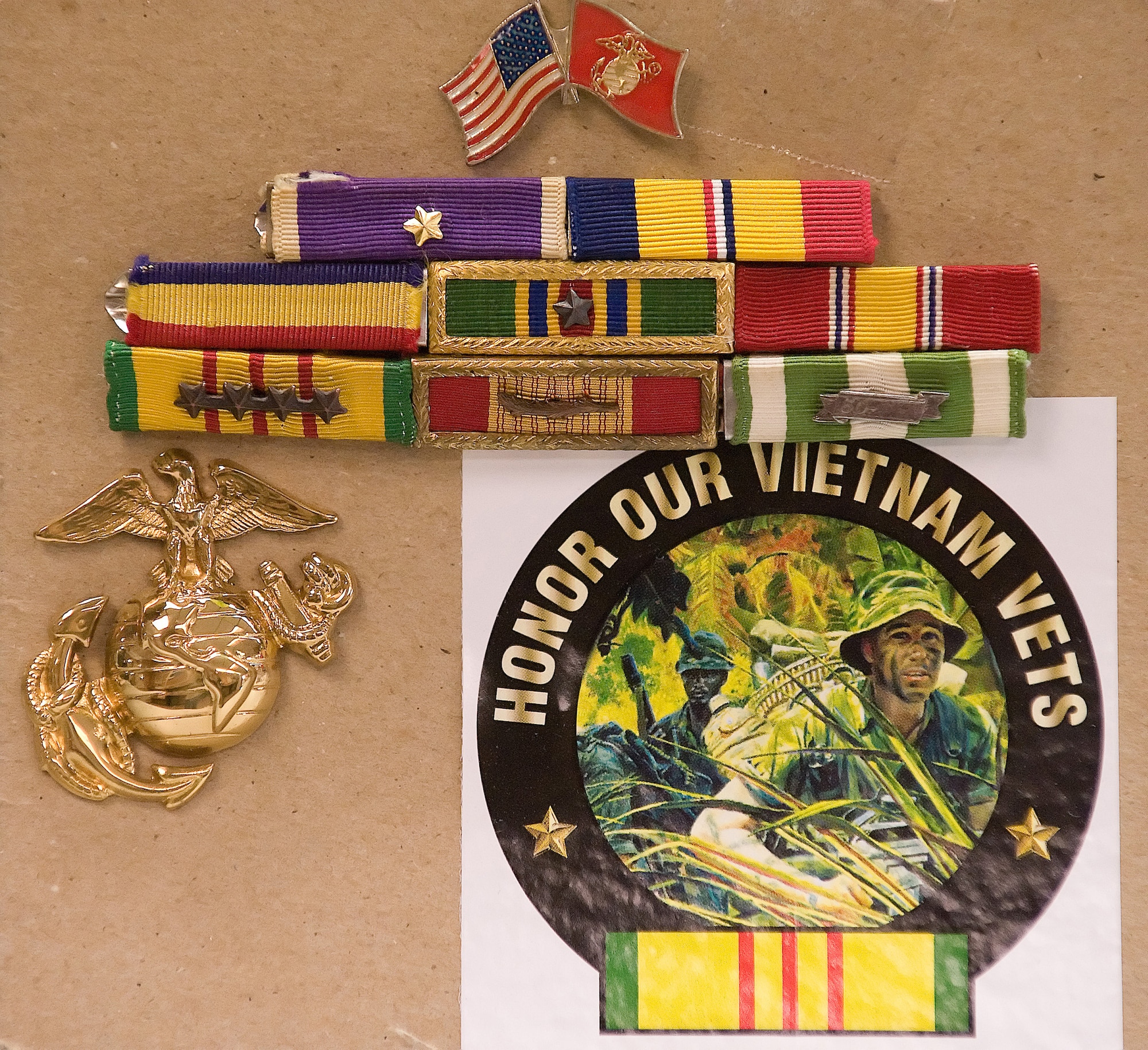 Fernando Martin displays his old ribbon rack on a piece of cardboard at his work center at the postal office on base. Within the first month of serving in the Vietnam Conflict he earned a Purple Heart. He earned two Purple Hearts during his deployment to Vietnam. (U.S. Air Force photo/Jason Minto)