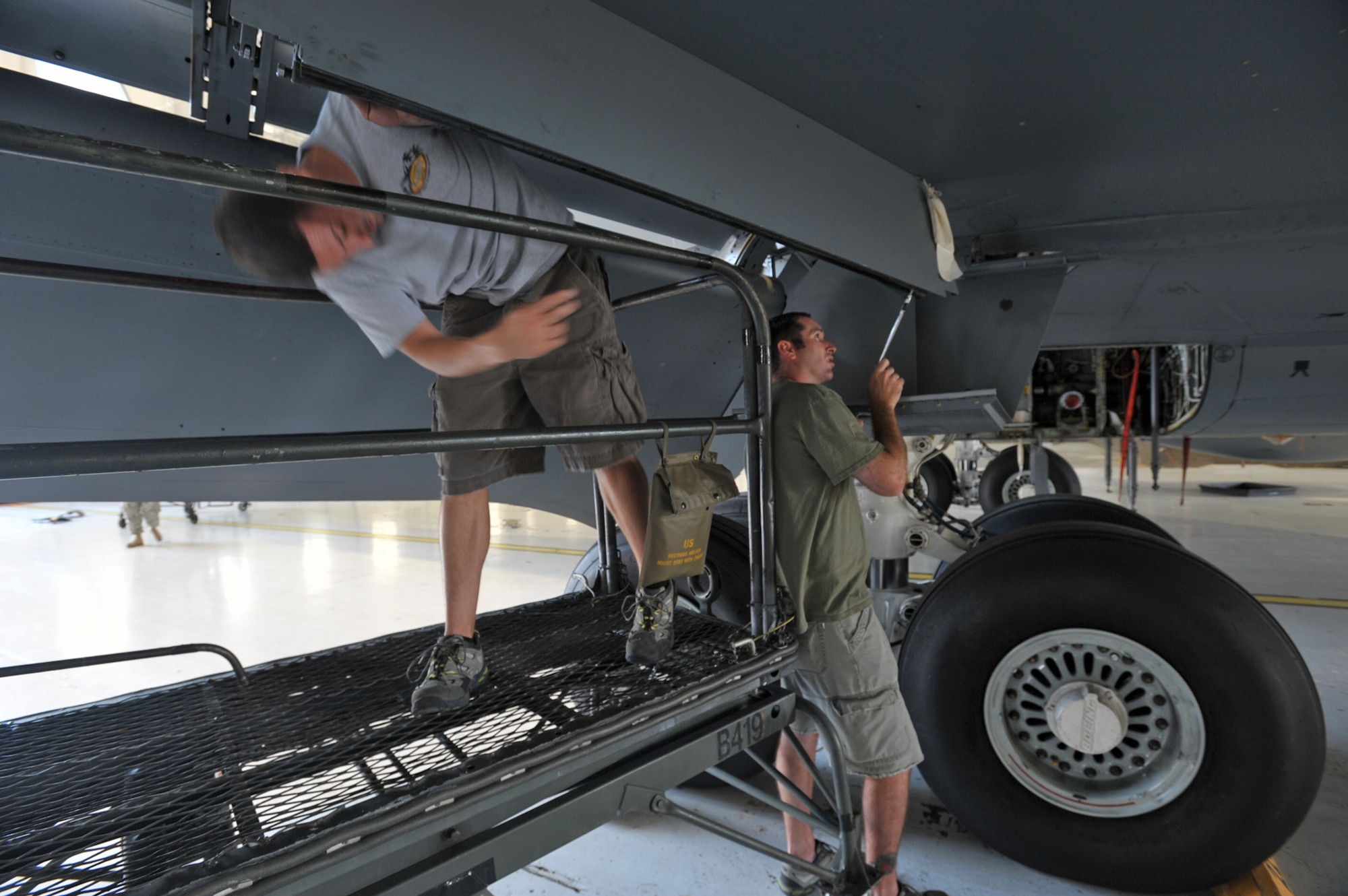 Tech. Sgt. Adam Keeter (on left) and Tech. Sgt. Seth Cullum work together to replace a seal at the bottom of a KC-135 Stratotanker in a hangar at McConnell Air Force Base, Kan. They are part of a "blended" Reserve and active-duty team preparing for Air Mobility Rodeo 2009. Sergeant's Keeter and Cullum work for the 931st Aircraft Maintenance Squadron at McConnell as air reserve technicians, full-time civilian employees who work in the same position they occupy as Reservists. (U.S. Air Force photo/Tech. Sgt. Jason Schaap)