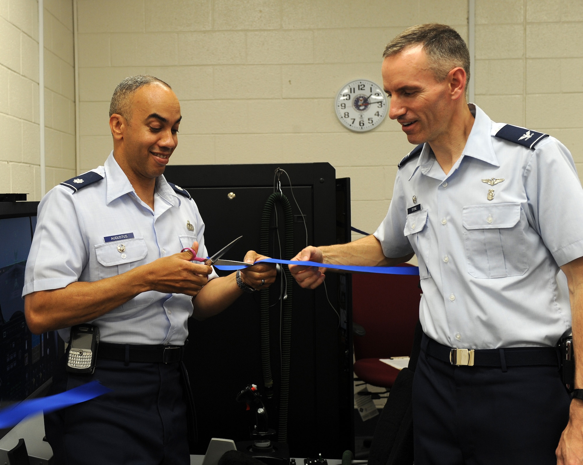 LANGLEY AIR FORCE BASE, Va. -- Lt. Col. Hans Augustus, 1st Fighter Wing vice commander, and Col. Eric Stone, 1st Medical Group commander, perform a ribbon cutting for the Reduced Oxygen Breathing Device trainer here June 29.  This device records a pilot's reaction to low oxygen levels and the first hypoxia trainer in the Air Force in over 60 years. (U.S. Air Force photo/Senior Airman Zachary Wolf)