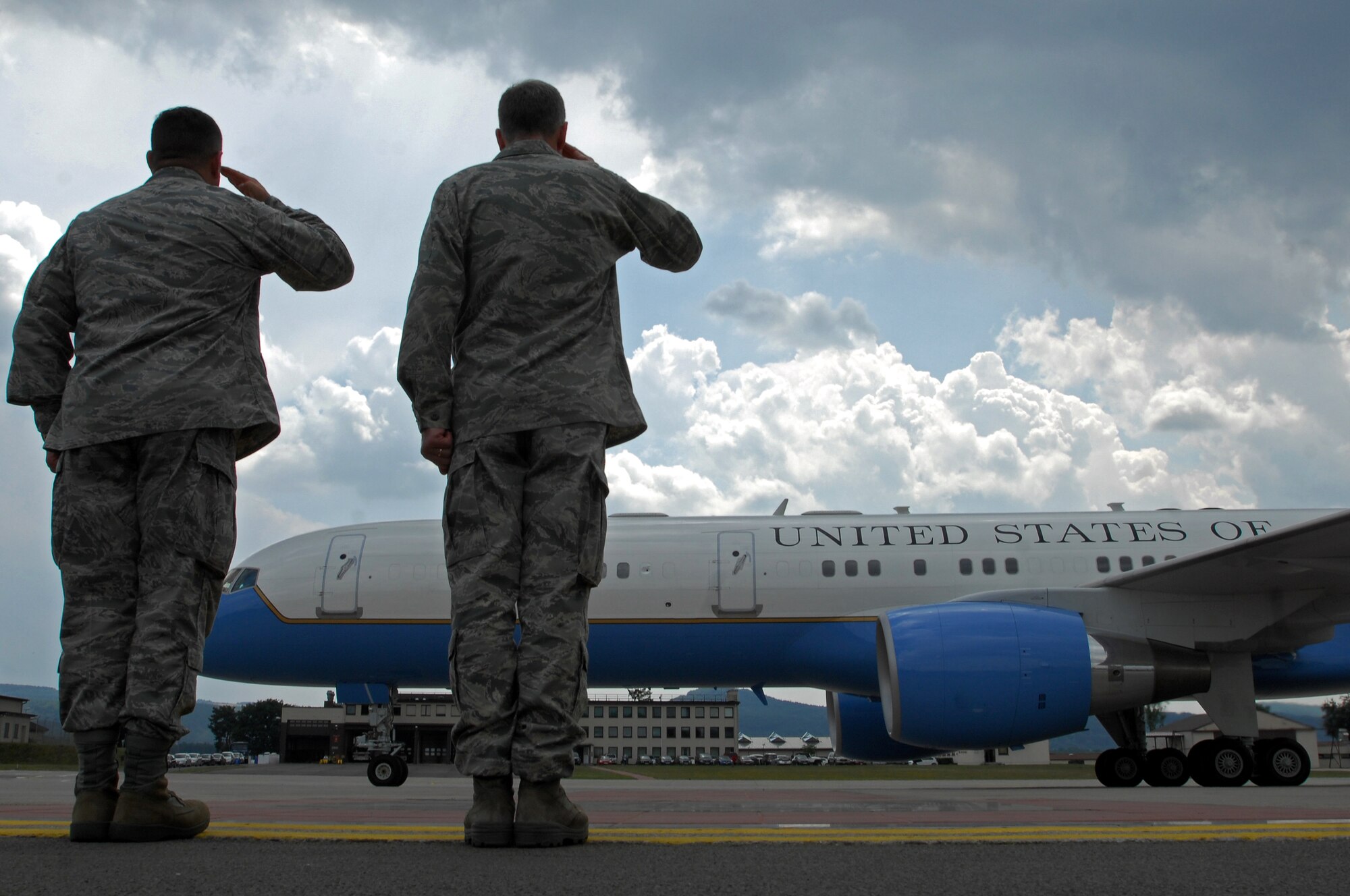 U.S. Air Force Col. Gus Green, 435th Air Base Wing vice commander and Maj. Gen. William Chambers, United States Air Forces in Europe vice commander, salute the plane of Secretary of Defense Robert M. Gates, June 30, 2009, Ramstein Air Base, Germany. Secretary Gates arrived at Ramstein en route to Landstuhl Regional Medical Center, Germany to visit wounded U.S. military members being treated there. (U.S. Air Force photo by Senior Airman Kenny Holston)