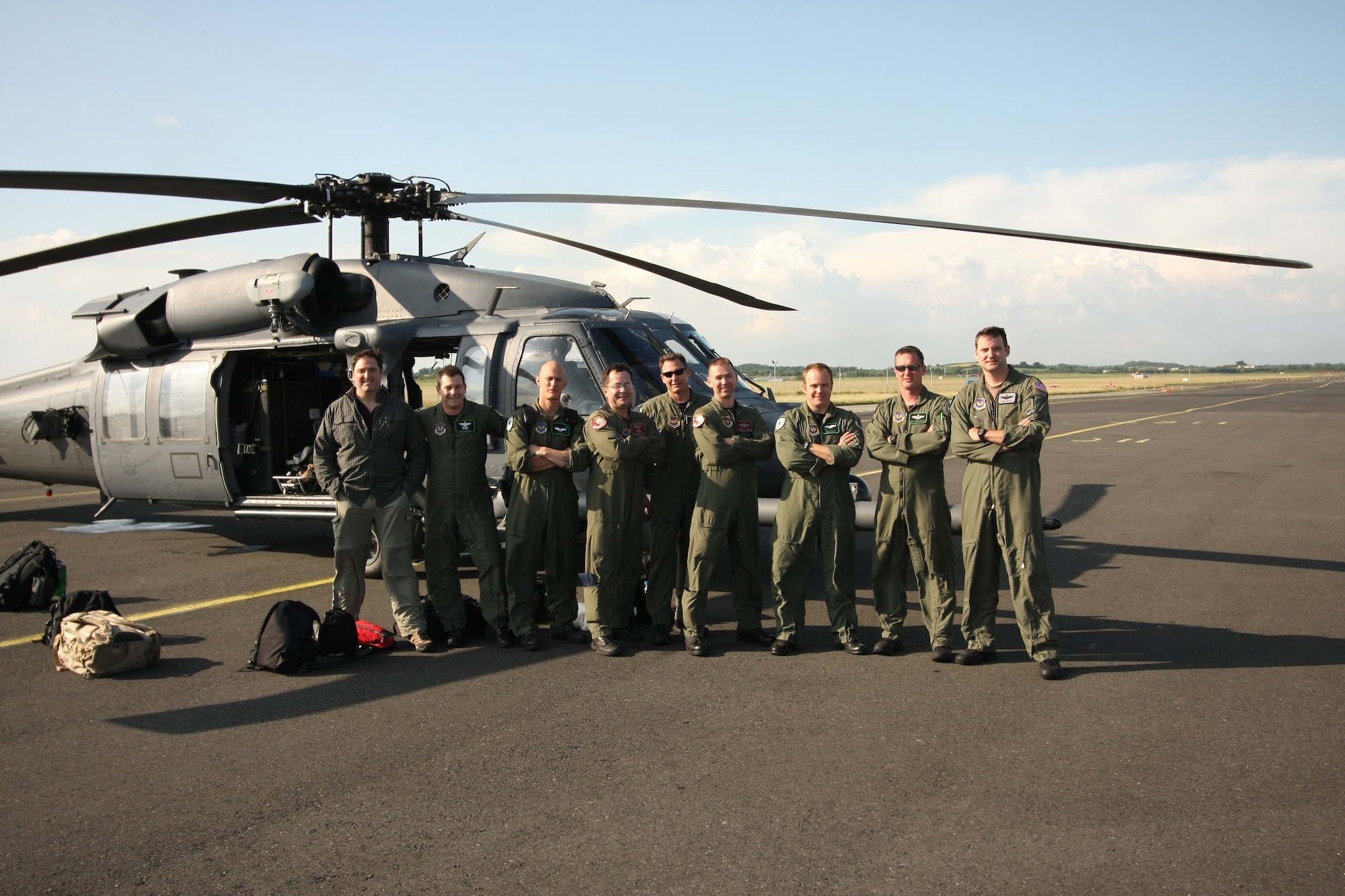Airmen of the 56th Rescue Squadron at RAF Lakenheath, England, pose in front of one of the two HH-60G Pave Hawks used in a rescue mission off the West coast of Ireland, June 26. The pararescue specialists and crew hoisted a sailor in need of emergent medical care onto their helicopter from the cargo ship, Pascha. The man was experiencing severe abdominal pain, requiring immediate medical evacuation. Two additional U.S. Air Force aircraft, a KC-135R Stratotanker from the 100th Air Refueling Wing and a MC-130P Combat Shadow from the 352nd Special Operations Group -- both from nearby RAF Mildenhall -- supported the operation for refueling and communication purposes. A Nimrod, search and rescue aircraft, from the United Kingdom also played a critical role in the operation, providing real time communication and coordination between the ship and USAF aircraft. The patient was delivered to an awaiting ambulance in Shannon, Ireland, and is in stable condition. (U.S. Air Force photo / Senior Airmen Michael Barber)