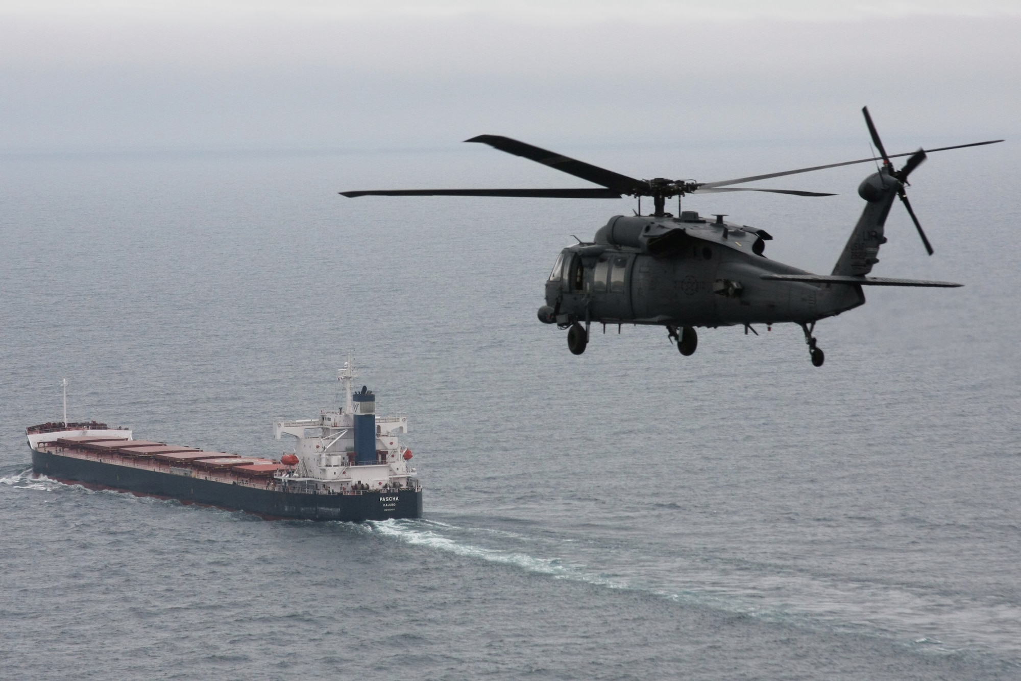 A 56th Rescue Squadron HH-60G Pave Hawk from RAF Lakenheath, England, flies toward the cargo ship Pascha, approximately 400 miles off of the West coast of Ireland, June 26. Two helicopters from the squadron made the journey to save a sailor who was experiencing severe abdominal pain and required immediate medical evacuation. Two additional U.S. Air Force aircraft, a KC-135R Stratotanker from the 100th Air Refueling Wing and a MC-130P Combat Shadow from the 352nd Special Operations Group -- both from nearby RAF Mildenhall -- supported the operation for refueling and communication purposes. A Nimrod, search and rescue aircraft, from the United Kingdom also played a critical role in the operation, providing real time communication and coordination between the ship and USAF aircraft. The patient was delivered to an awaiting ambulance in Shannon, Ireland, and is in stable condition. (U.S. Air Force photo/Master Sgt. Jay Reinschi.)