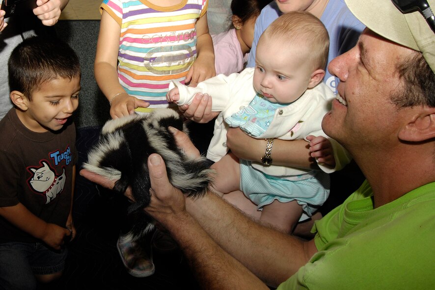 HANSCOM AIR FORCE BASE, Mass. – Miles Raker (left) and Madison Forbush meet one of the curious creatures that visited the Hanscom Child Development Center on June 25. Children had the opportunity to interact with and learn about mammals, amphibians, reptiles and arachnids during the Curious Creatures visit to the center. (U.S. Air Force photo by Linda LaBonte Britt) 