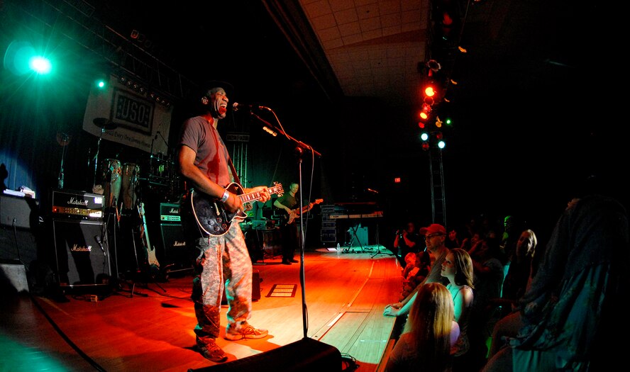 Guitar player Kimo Williams of "The Lt. Dan Band" performs for a standing room only crowd, June 28, at the Osan Air Base, Republic of Korea, base theater. The band's mission is to do what it can to draw attention to military service members, their families and veterans and to make sure they know they are remembered and appreciated. (U.S. Air Force photo/Staff Sgt. Brian Ferguson)