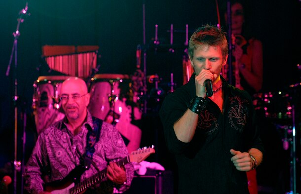 Ernie Denov and Jeff Vezain of "The Lt. Dan Band" perform for a standing room only crowd, June 28, at the Osan Air Base, Republic of Korea, base theater. The band's mission is to do what it can to draw attention to military service members, their families and veterans and to make sure they know they are remembered and appreciated. (U.S. Air Force photo/Staff Sgt. Brian Ferguson)