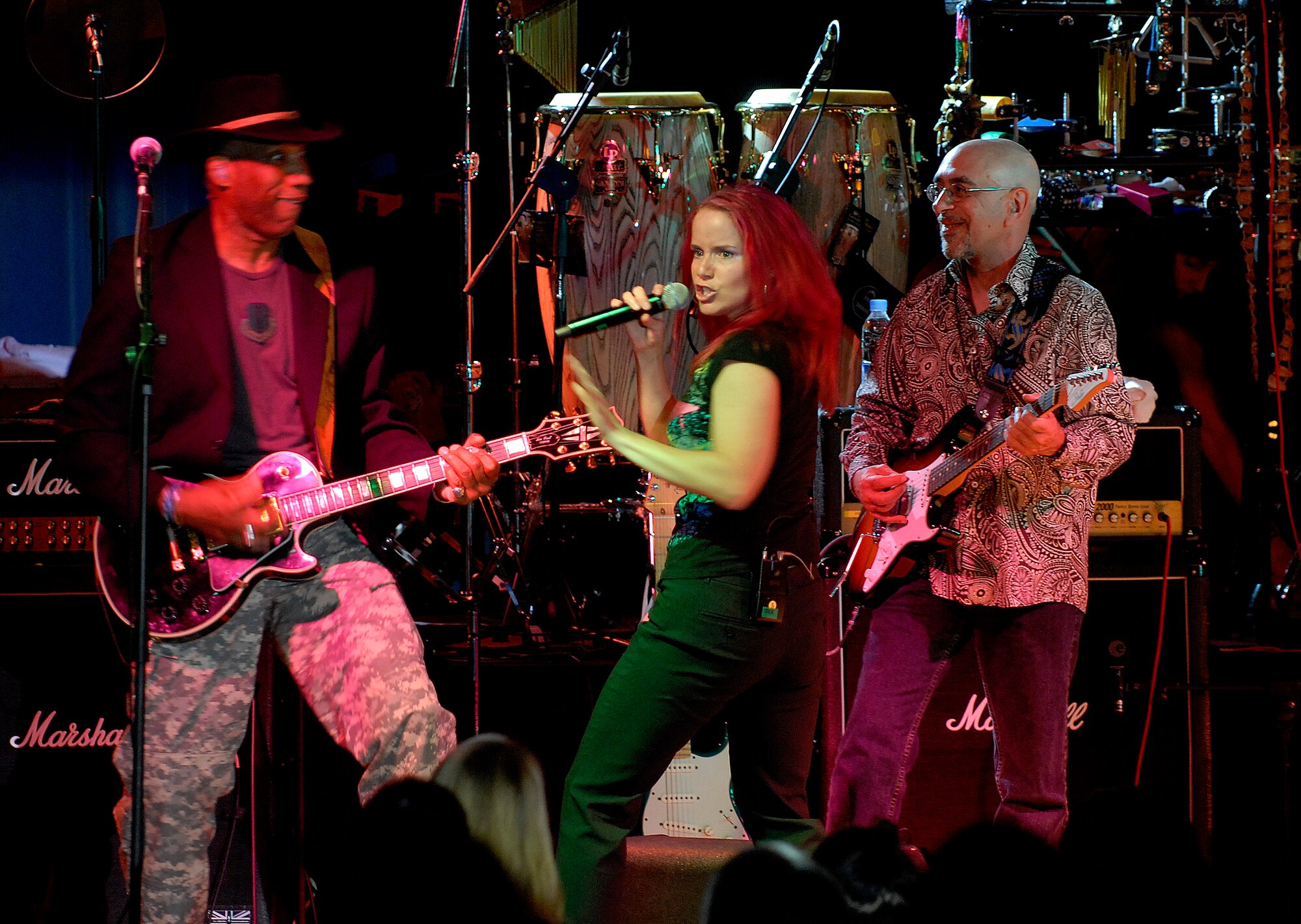 (Left to right) Kimo Williams, Julie Dutchak and Ernie Denov  of "The Lt. Dan Band" perform for a standing room only crowd, June 28, at the Osan Air Base, Republic of Korea, base theater. The band's mission is to do what it can to draw attention to military service members, their families and veterans and to make sure they know they are remembered and appreciated. (U.S. Air Force photo/Staff Sgt. Brian Ferguson)



