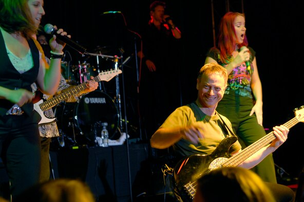 Gary Sinise of "The Lt. Dan Band" interacts with the audience as the band plays for a standing room only crowd, June 28, at the Osan Air Base, Republic of Korea, base theater. The band's mission is to do what it can to draw attention to military service members, their families and veterans and to make sure they know they are remembered and appreciated. (U.S. Air Force photo/Staff Sgt. Brian Ferguson)