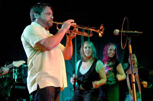 Trumpet player Kirk Garrison of "The Lt. Dan Band" plays for a standing room only crowd, June 28, at the Osan Air Base, Republic of Korea, base theater. The band's mission is to do what it can to draw attention to military service members, their families and veterans and to make sure they know they are remembered and appreciated. (U.S. Air Force photo/Staff Sgt. Brian Ferguson)