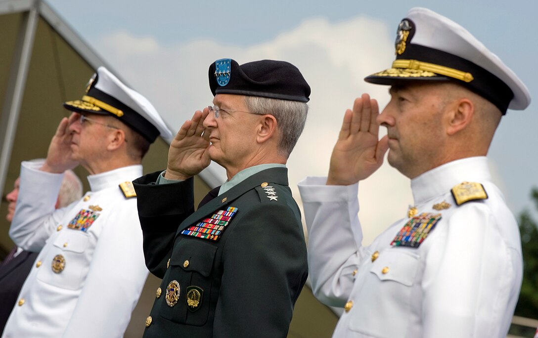 U.S. Navy Adm. Mike Mullen, chairman of the Joint Chiefs of Staff, U.S. Army Gen. John Craddock, outgoing commander, and U.S. Navy Adm. James G. Stavridis, incoming commander, salute during the national anthem at the U.S. European Command change of command ceremony at Patch Barracks in Stuttgart, Germany, June 30, 2009.