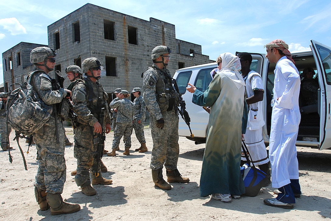 U.S. Army Cpt. Andrew Salmo, center, answers questions from evacuees before moving them during a noncombatant evacuation training exercise conducted by the 82nd Airborne Division's 2nd Brigade Combat Team on Camp Mackall, N.C., June 25, 2009. Salmo is the commander of Company A., 1st Battalion, 325th Airborne Infantry Regiment. The exercise tested the unit's ability to deploy on short notice to help evacuate American citizens and others trapped in a war-torn third-world country.