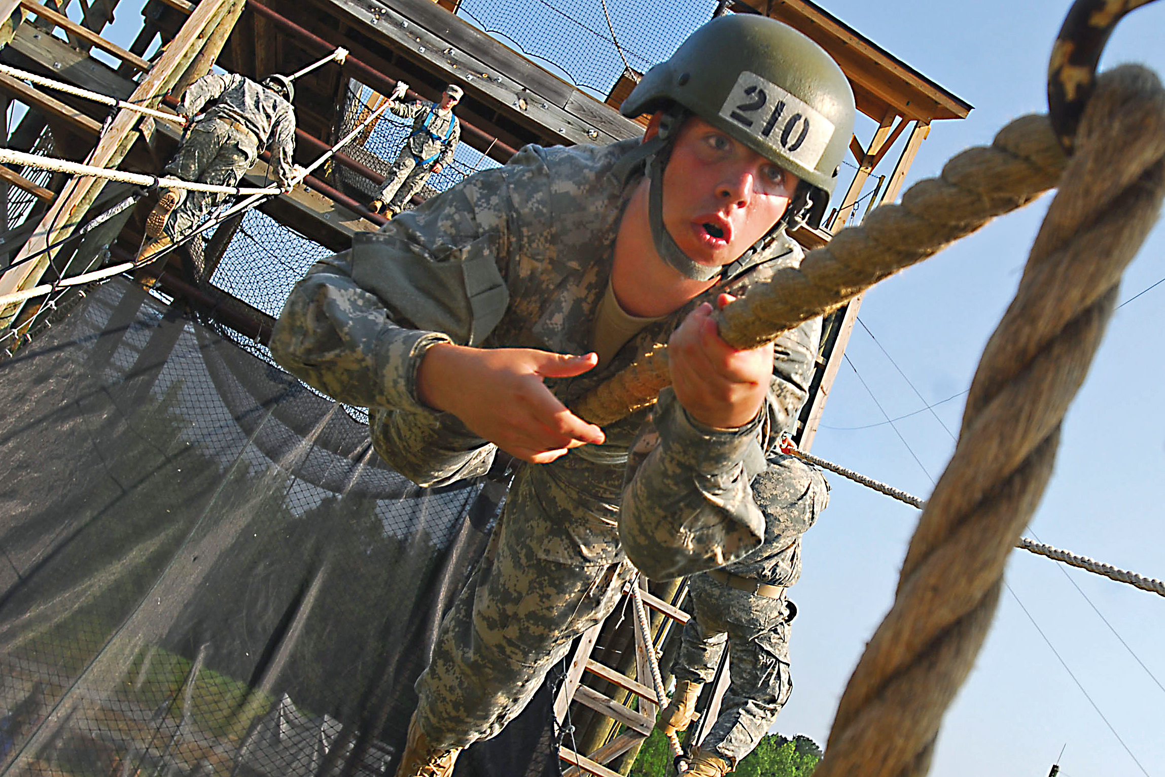 U.S. Army Pfc. Augustus Dawson uses the Army crawl to cross a one