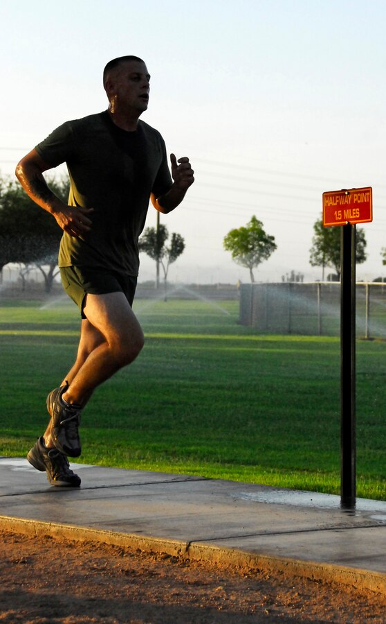 Sgt. Josh Rookey, station emergency air craft recovery crew leader, runs past the half way point of the physical fitness test course at the Marine Corps Air Station in Yuma Ariz., during a Headquarters and Headquarters Squadron PFT June 30, 2009. Active duty Marines are required to run two PFTs annually, one before June 30 and one before Dec. 31.