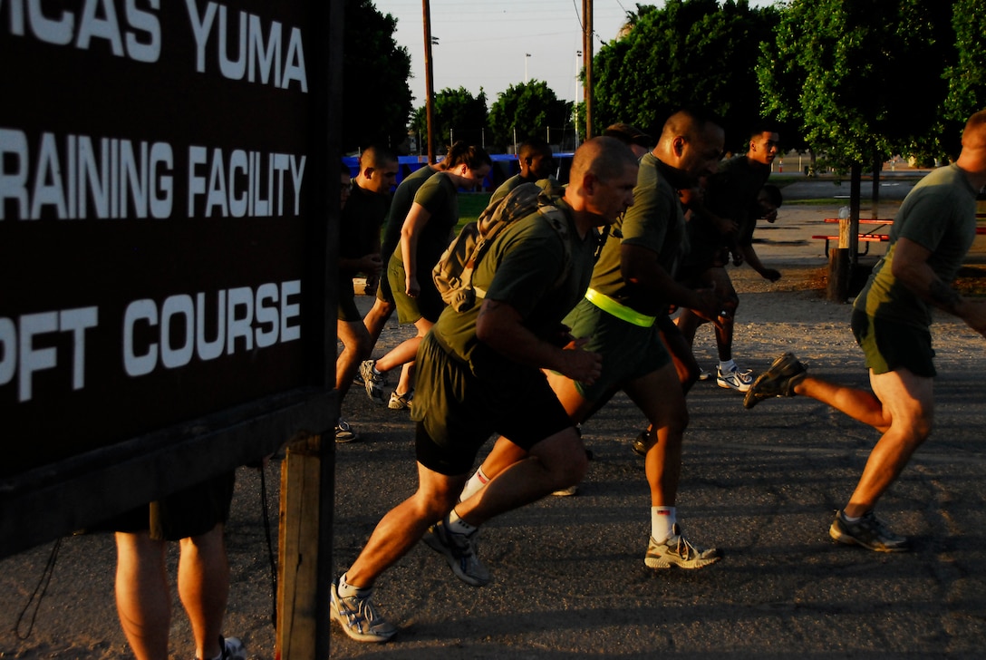 Headquarters and Headquarters Squadron Marines take off running at the starting point of the Marine Corps Air Station’s physical fitness test course in Yuma, Ariz., June 30, 2009. Active duty Marines are required to run two PFTs annually, one before June 30 and one before Dec. 31.