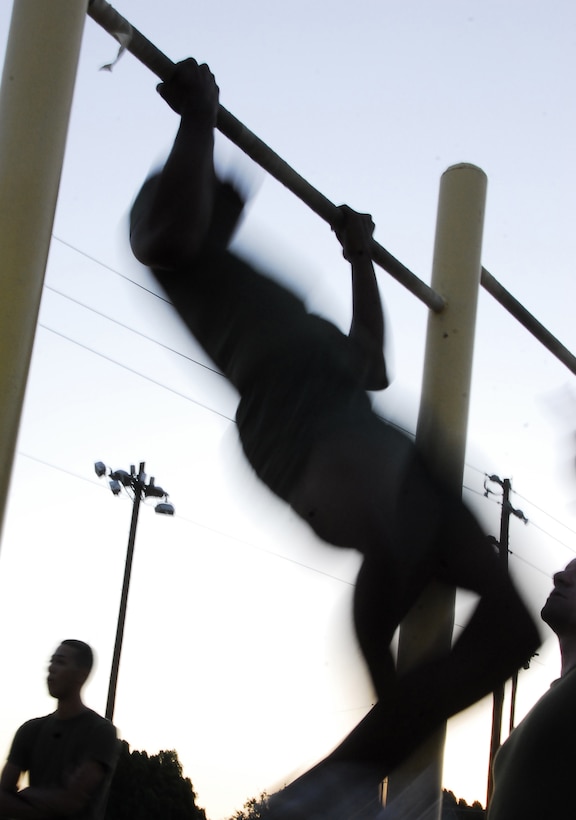 Pvt. Miles Gipson, station administrative clerk, pumps out a pull-up during a Headquarters and Headquarters Squadron physical fitness test at the Marine Corps Air Station in Yuma, Ariz., June 30, 2009. Active duty Marines are required to run two PFTs annually, one before June 30 and one before Dec. 31.