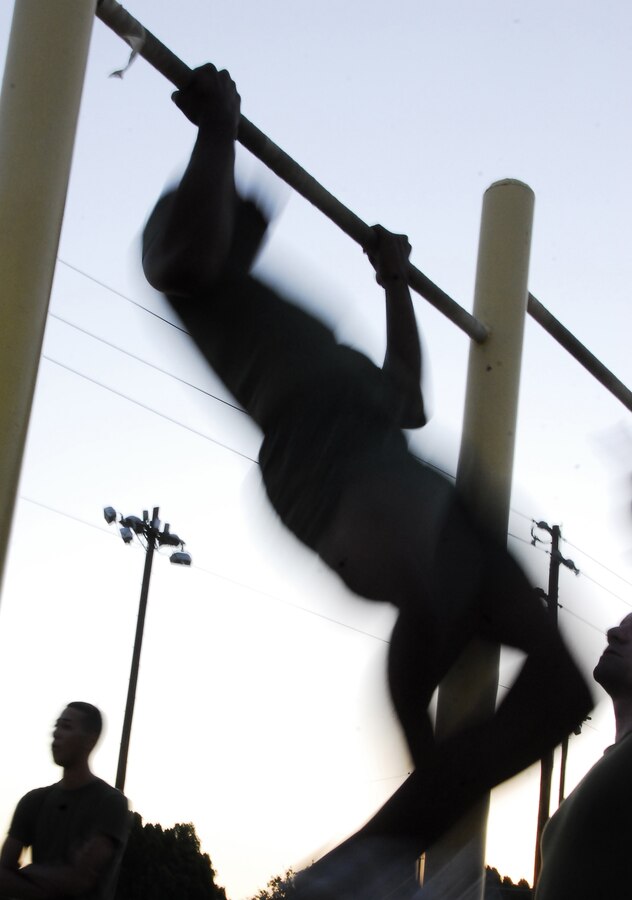 Pvt. Miles Gipson, station administrative clerk, pumps out a pull-up during a Headquarters and Headquarters Squadron physical fitness test at the Marine Corps Air Station in Yuma, Ariz., June 30, 2009. Active duty Marines are required to run two PFTs annually, one before June 30 and one before Dec. 31.