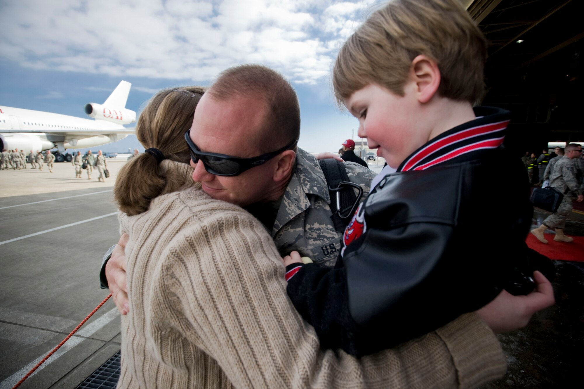 MISAWA AIR BASE, Japan -- Staff Sgt. Adam Yeo, 35th Maintenance Squadron phase crewchief, hugs his family March 1, 2009. Sergeant Yeo returned from a deployment to Joint Base Balad, Iraq, in support of the 14th Fighter Squadron. He and his family hail from Florida. (U.S. Air Force photo by Staff Sgt. Samuel Morse)