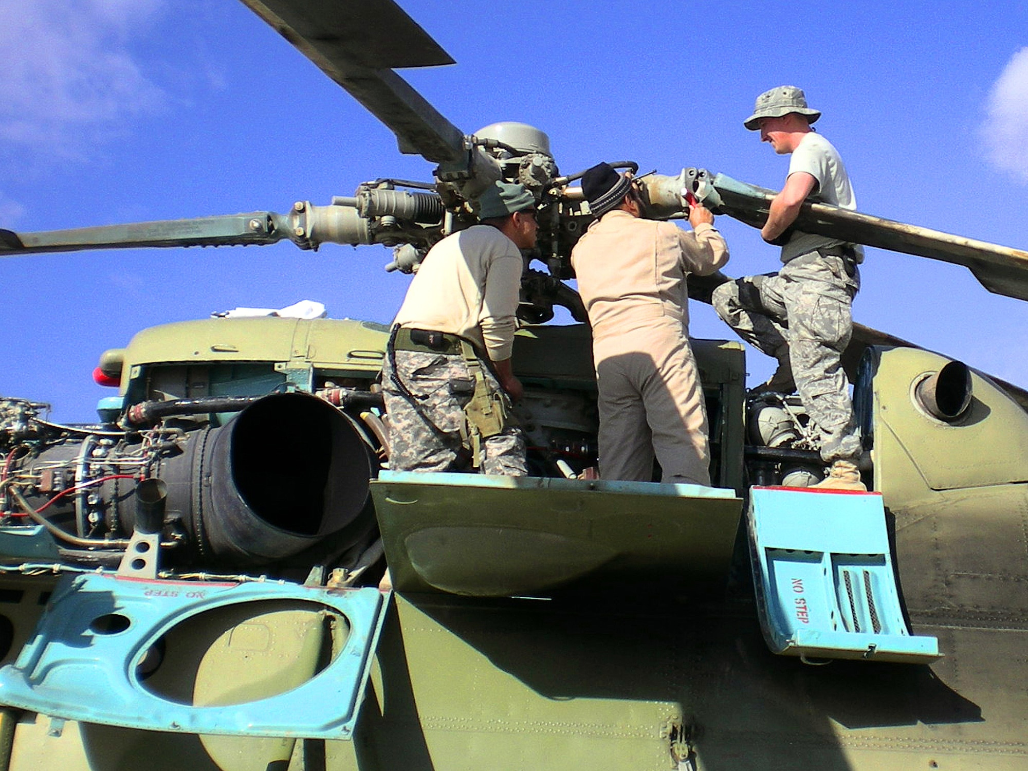 Tech. Sgt. Dennis Flanagan advises Afghan Air Corps maintainers on the Russian-made MI-17 transport helicopter.  Tech. Sgt. Flanagan and Tech. Sgt. Brian Roberts are mentoring Afghan Air Corps maintainers at Kandahar Air Base, Afghanistan.  Both Airmen are assigned to the 718th Aircraft Maintenance Squadron at Kadena Air Base, Japan. (Courtesy photo)