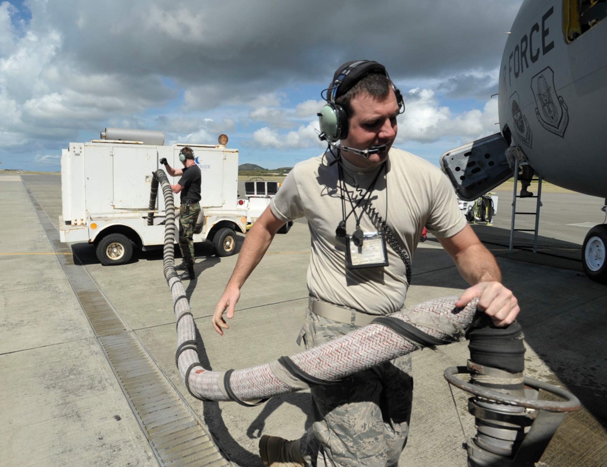 Staff Sgt. Scott Perkins carries an air hose to a KC-135 Stratotanker at an airfield in St. Croix, U.S. Virgin Islands. The tanker was being prepared to depart for the end of a three-day aeromedical evacuation training mission supported by the 931st Air Refueling Group. Sergeant Perkins is a crew chief assigned to the 931st Aircraft Maintenance Squadron. (U.S. Air Force photo/Tech. Sgt. Jason Schaap)