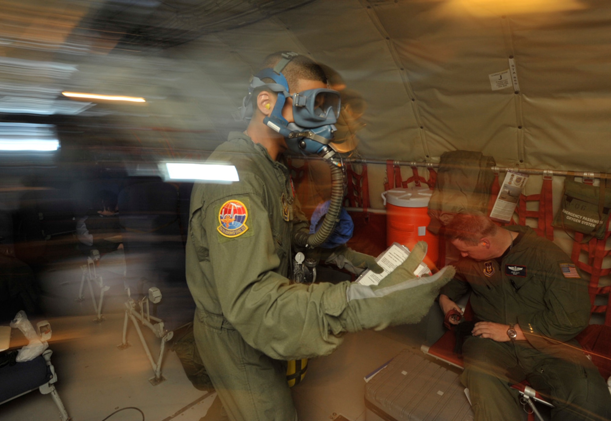 Senior Airman Elvin Paulino rushes to fight a simulated in-flight fire in the rear of a KC-135 Stratotanker Sunday. The simulation was part of a three-day aeromedical evacuation training mission using a KC-135 flown by Airmen from the 931st Air Refueling Group. Airman Paulino is assigned to the 514th Aeromedical Evacuation Squadron at McGuire Air Force Base, N.J. (U.S. Air Force photo/Tech Sgt. Jason Schaap)