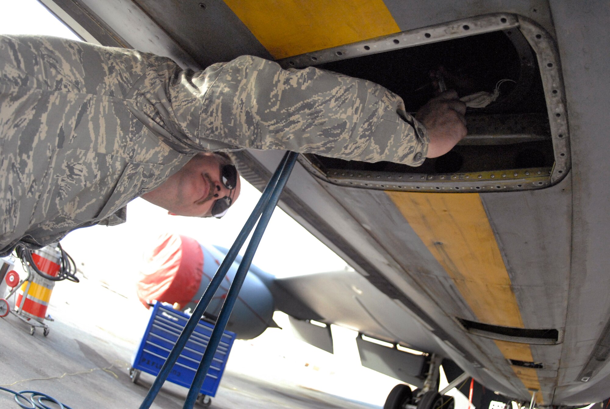 Master Sergeant Mark Lebel, 379th Expeditionary Maintenance Squadron Shift Leader, hands tools and equipment to Airmen during the replacement of a fuel bladder inside a KC-135R Stratotanker, Feb. 27, 2009, at an undisclosed location in Southwest Asia.  Master Sgt. Lebel hails from Rochester, N.H. and is deployed from Pease Air National Guard Base, N.H. in support of Operations Iraqi and Enduring Freedom and Combined Joint Task Force - Horn of Africa.  (U.S. Air Force photo/Senior Airman Andrew Satran/released)