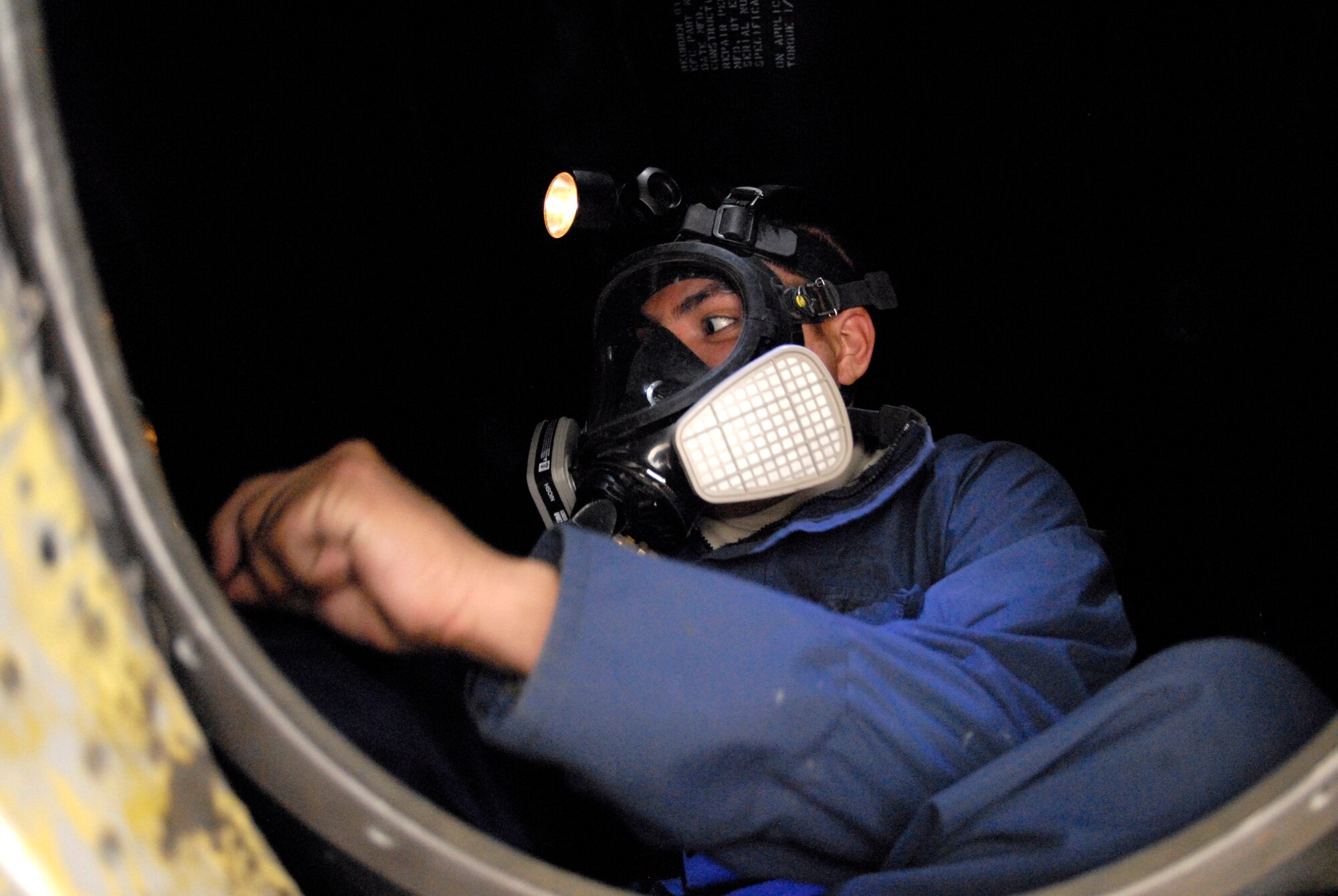Airman 1st Class Rodolfo Quiroz, a 379th Expeditionary Maintenance Squadron Aircraft Fuel Systems Repair Apprentice, is in the forward body fuel cell of a KC-135R Stratotanker removing the fuel bladder, Feb. 27, 2009, at an undisclosed location in Southwest Asia.  Airman Quiroz hails from Bay City, Mich. and is deployed from McConnell Air Force Base, Kan. in support of Operations Iraqi and Enduring Freedom and Combined Joint Task Force - Horn of Africa. (U.S. Air Force photo/Senior Airman Andrew Satran/released)