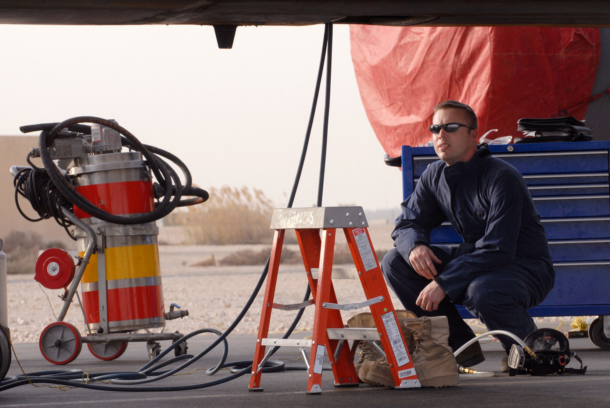 Staff Sergeant Rodney Apperson, a 379th Expeditionary Maintenance Squadron Aircraft Fuel Systems Repair Craftsman, stands by with equipment to ensure the safety of two Airmen working inside a forward body fuel cell of a KC-135R Stratotanker, Feb. 27, 2009, at an undisclosed location in Southwest Asia.  Staff Sgt. Apperson hails from Albany, Ga. and is deployed from Seymour Johnson Air Force Base, N.C. in support of Operations Iraqi and Enduring Freedom and Combined Joint Task Force - Horn of Africa. (U.S. Air Force photo/Senior Airman Andrew Satran/released)