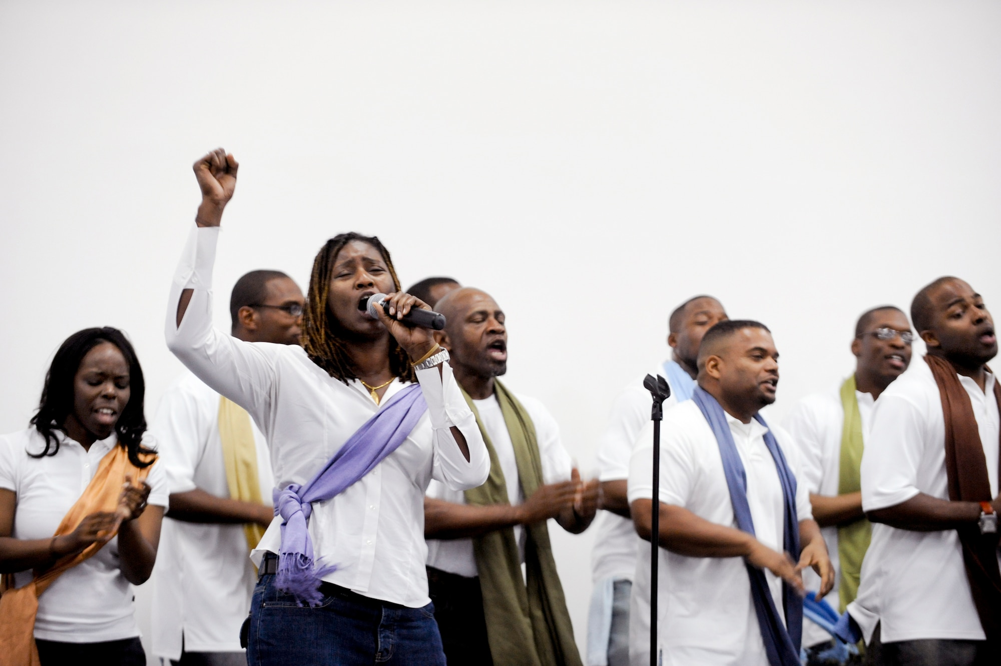 Members from The Victory Chapel Gospel Choir sing a song in praise during the Gospel Extravaganza event here, Feb. 27, 2009, in an undisclosed location in Southwest Asia.  The event featured choirs and dancers from different bases showcasing their musical and artistic talent.  The members of the choir consisted of military as well as civilian personnel who are deployed in support of Operations Iraqi and Enduring Freedom and Combined Joint Task Force - Horn of Africa. (U.S. Air Force Photo by Staff Sgt. Joshua Garcia/released)