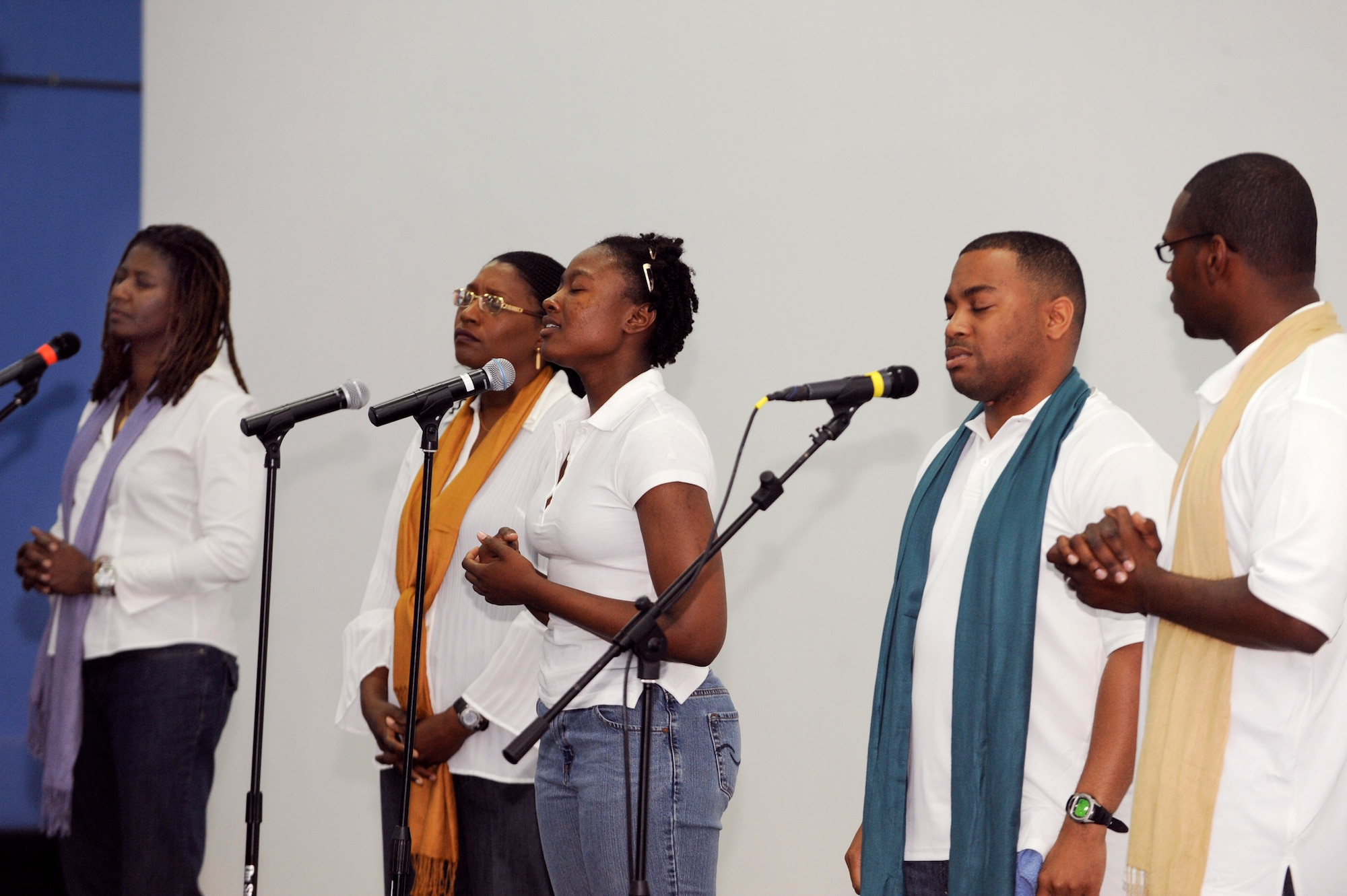 Members from a Gospel Choir sing a song in praise during a Gospel Extravaganza event, Feb. 27, 2009, in an undisclosed location in Southwest Asia.  The event featured choirs and dancers from different bases showcasing their musical and artistic talent.  The members of the choir consisted of military as well as civilian personnel who are deployed in support of Operations Iraqi and Enduring Freedom and Combined Joint Task Force - Horn of Africa. (U.S. Air Force Photo by Staff Sgt. Joshua Garcia/released)