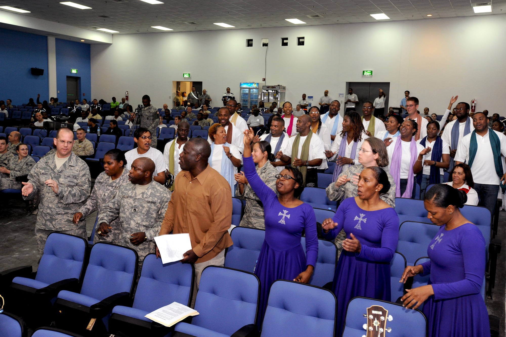 The crowd sings along to a performance by a Gospel Choir during the Gospel Extravaganza event, Feb. 27, 2009, in an undisclosed location in Southwest Asia.  The event, which was open to the public, allowed all to come and sing in the word of god.  The event showcased dance and song performances from choirs and dancers from different bases deployed in support of Operation Iraqi and Enduring Freedom and Combined Joint Task Force - Horn of Africa. (U.S. Air Force Photo by Staff Sgt. Joshua Garcia/released)