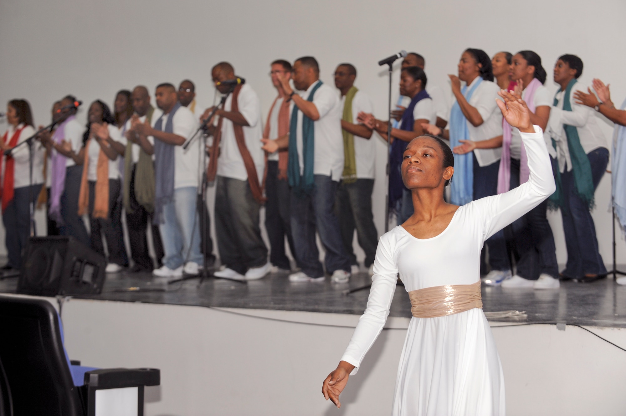 Staff Sgt. Nicole Whitted, a member of the Victory Gospel Chapel Dancers dances as the Victory Gospel Chapel Choir sings a song of praise during the Gospel Extravaganza here, Feb. 27, 2009, in an undisclosed location in Southwest Asia.  The event allowed members from various bases to come and sing and dance to songs of praise.  Sergeant Whitted is native to Columbus Ohio, and deployed from Altus Air Force Base, Okla. to the Combined Air and Space Operations Center in support of Operations Iraqi and Enduring Freedom and Combined Joint Task Force - Horn of Africa.(U.S. Air Force Photo by Staff Sgt. Joshua Garcia)