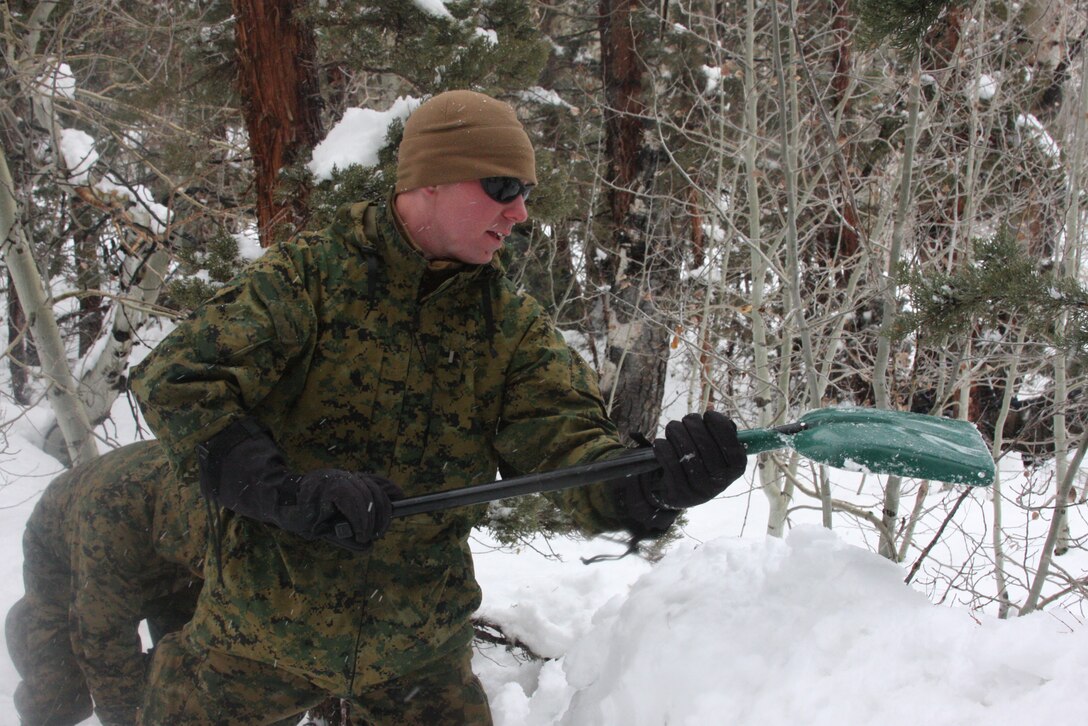 2nd Lt. Joel C. Gorder, the 2nd platoon commander of Company K, 3rd Battalion, 4th Marine Regiment, packs down snow to create a wall for his bivouac, or camp area, during the unit’s Mountain Warrior Exercise at Aspen Bowl, a training area at Marine Corps Mountain Warfare Training Center, Bridgeport, Calif., March 2.