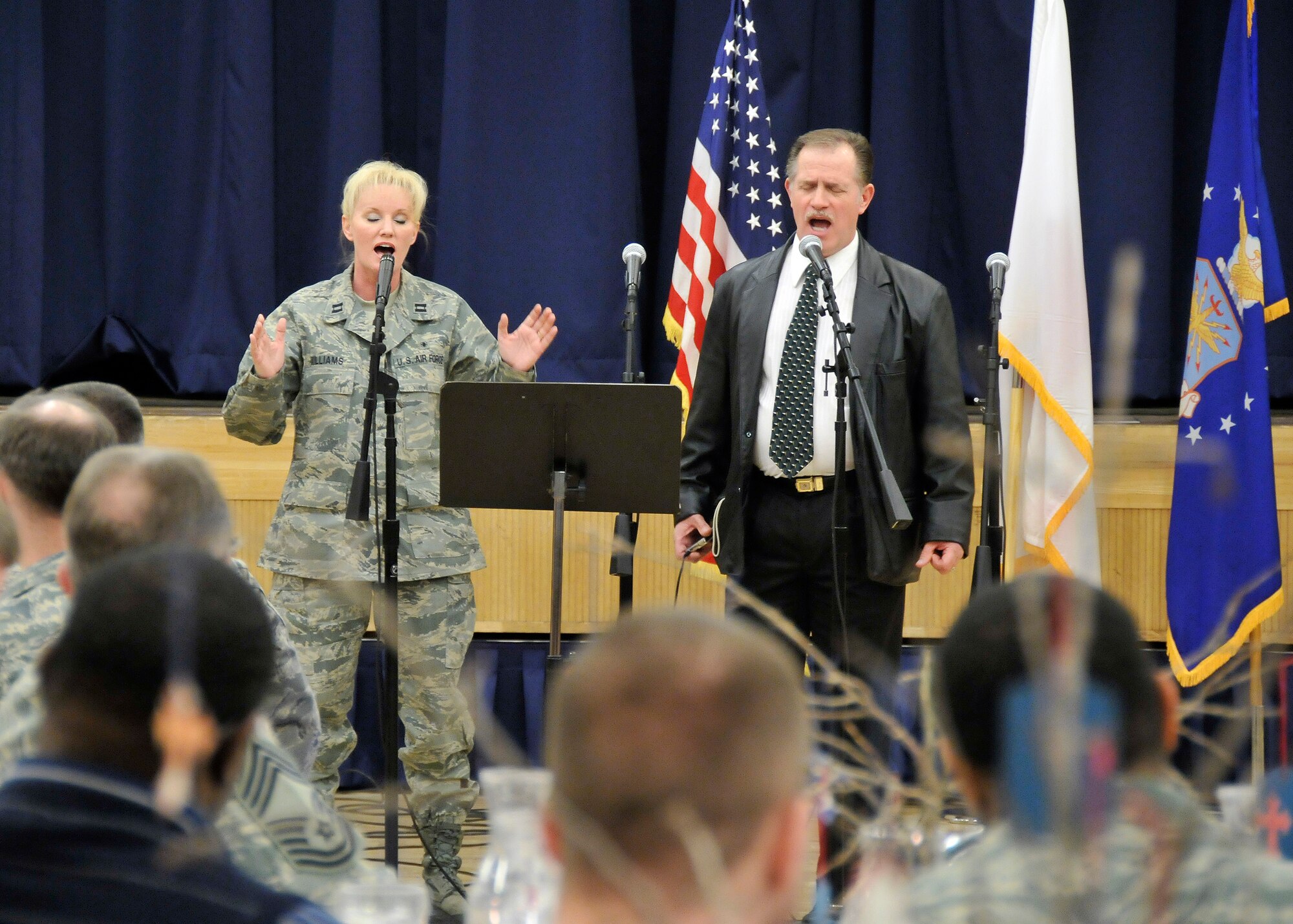 MISAWA AIR BASE, Japan -- Capt. Cris Williams, 35th Medical Operations Squadron, and her husband Herman Williams, sing several songs during the National Prayer Luncheon Feb. 23, 2009. Nearly 200 service and family members attended the ceremony. (U.S. Air Force photo by Senior Airman Chad Strohmeyer) 