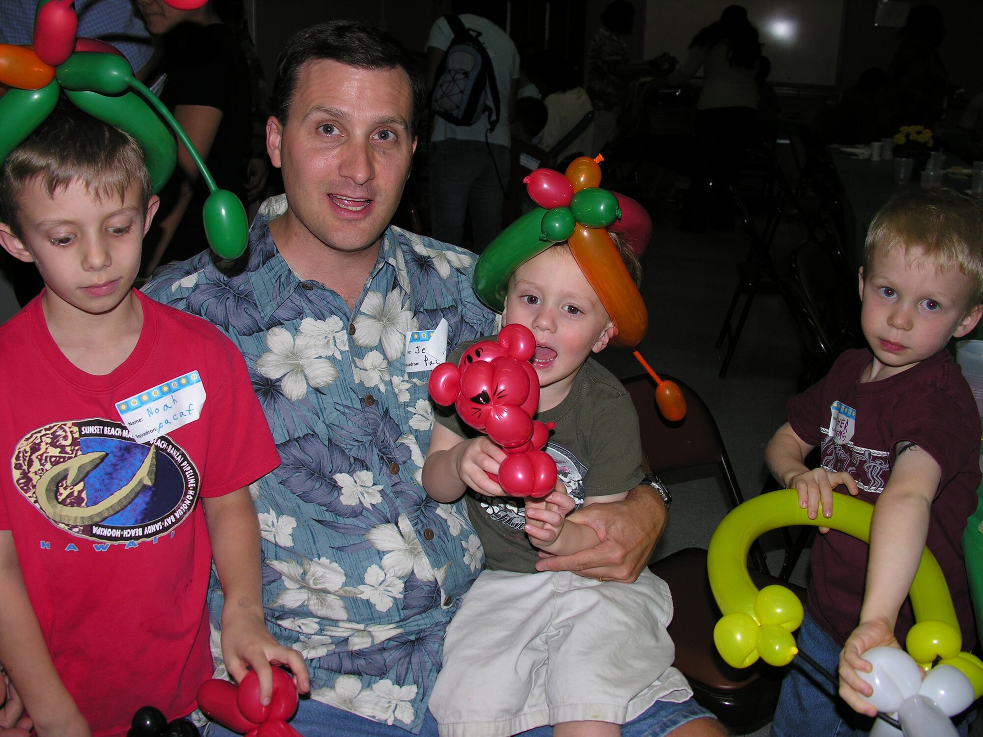 The family of Major Mitzi Weems, PACAF/JA, who currently deployed to Bagdad, was among 100 family members who attended on Thursday, 26 Feb, at the deployment dinner.  From left, Noah (8-year old son), Jeff (husband), Nathaniel (3-year old son), and Asher (6-year old son). (U.S. Air Force photo/Jackie Hites)