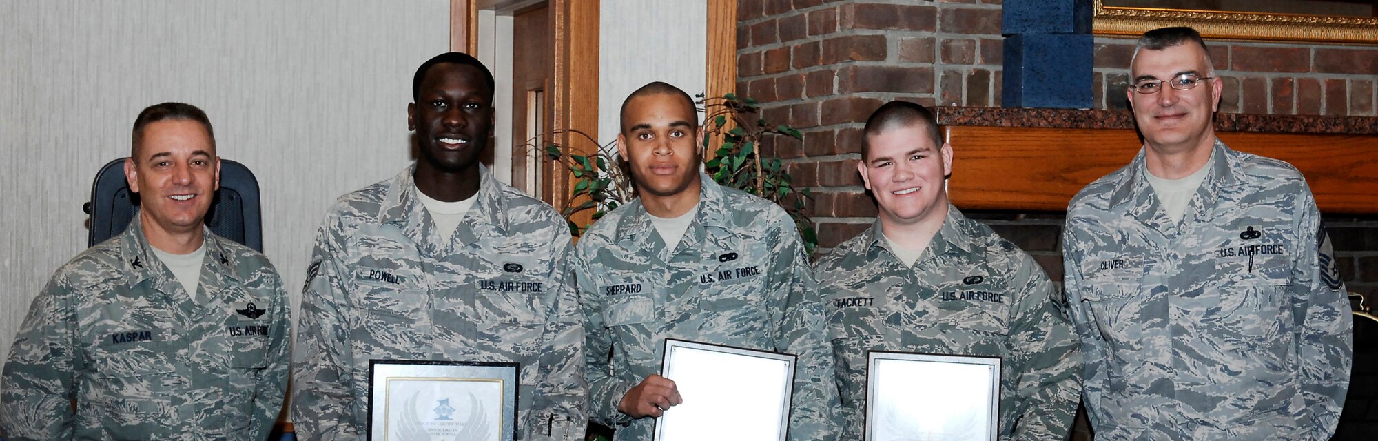 CANNON AIR FORCE BASE, N.M. -- (Left) Col. Ruedi Kaspar, 27th Special Operations Wing vice wing commander, and (right) Chief Master Sgt. Philip Oliver, 27th Special Operations Maintenance Group, stand with February's Diamond Sharp Award winners Senior Airman Lester Powell, 27th Special Operations Force Support Squadron, Airman 1st Class Michael Sheppard, 27th Special Operations Logistics Readiness Squadron and Airman 1st Class Jacob Tackett, 27th Special Operations Contracting Squadron. These Airmen received their awards Feb. 27 at the Pecos Trail Dining Facility for their outstanding performance in their military careers. (Air Force photo/Airman 1st Class Danielle Martin)