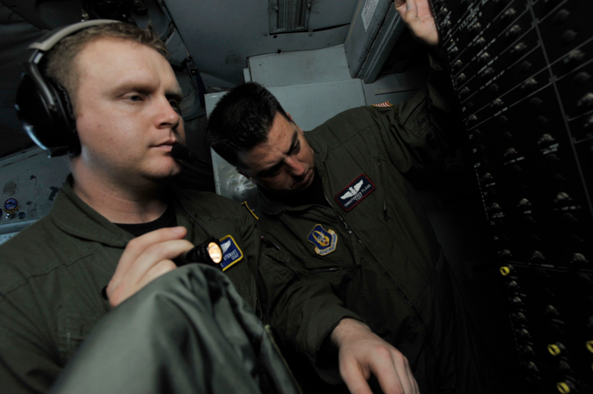 Staff Sgt. Kenny Stewart (left) and Tech. Sgt. Christopher Flagg search for a tripped light circuit on a KC-135 Stratotanker. The two Airmen were part of an aeromedical evacuation training team that included members from the 931st Air Refueling Group and the 514th Aeromedical Evacuation Squadron. Sergeant Stewart is a KC-135 boom operator for the 931st and Sergeant Flagg is an aeromedical evacuation instructor for the 514th. (U.S. Air Force photo/Tech. Sgt. Jason Schaap)