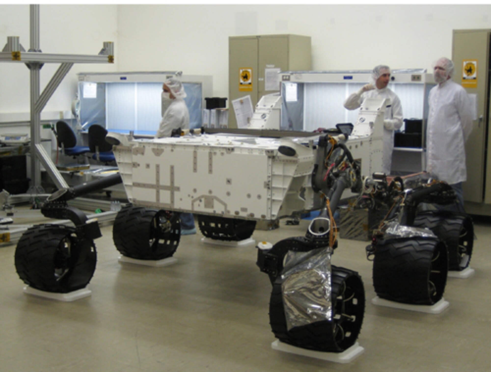 Wheels were first attached to NASA’s Mars Science Laboratory rover in August 2008. The rover and its descent stage and cruise stage are being assembled and tested at  NASA’s Jet Propulsion Laboratory, Pasadena, Calif., for launch in 2011. The rover has a ground clearance of about 60 centimeters, or 2 feet. The wheel base is 2.2 meters, or 7 feet. (Photo courtesy: NASA/JPL-Caltech)
