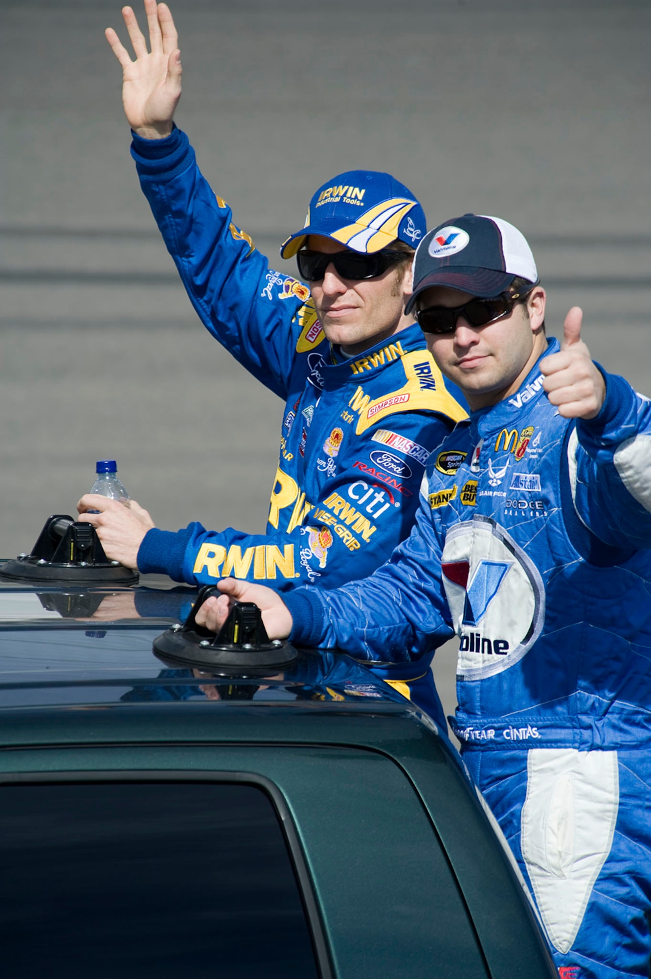 Sprint Cup drivers Reed Sorenson (front) and Jamie McMurray wave to the crowd during driver introductions for the Shelby 427 race March 1 at the Las Vegas Motor Speedway. Mr. Sorenson, driver of the No. 43 Air Force sponsored Dodge, finished the race in 34th place after spinning in turn two on lap 138.  (U.S. Air Force photo/Master Sgt. Jack Braden)