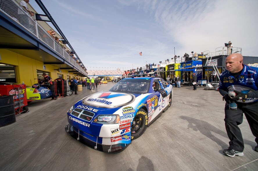 Jeff Seaberg guides Reed Sorenson into the garage area during the first Sprint Cup practice session Feb. 28 at Las Vegas Motor Speedway in Nevada. Mr. Seaberg is the truck driver and catch-can man for the Air Force sponsored No. 43 Dodge, and Mr. Sorenson is the driver of the No. 43 car. (U.S. Air Force photo/Master Sgt. Jack Braden)