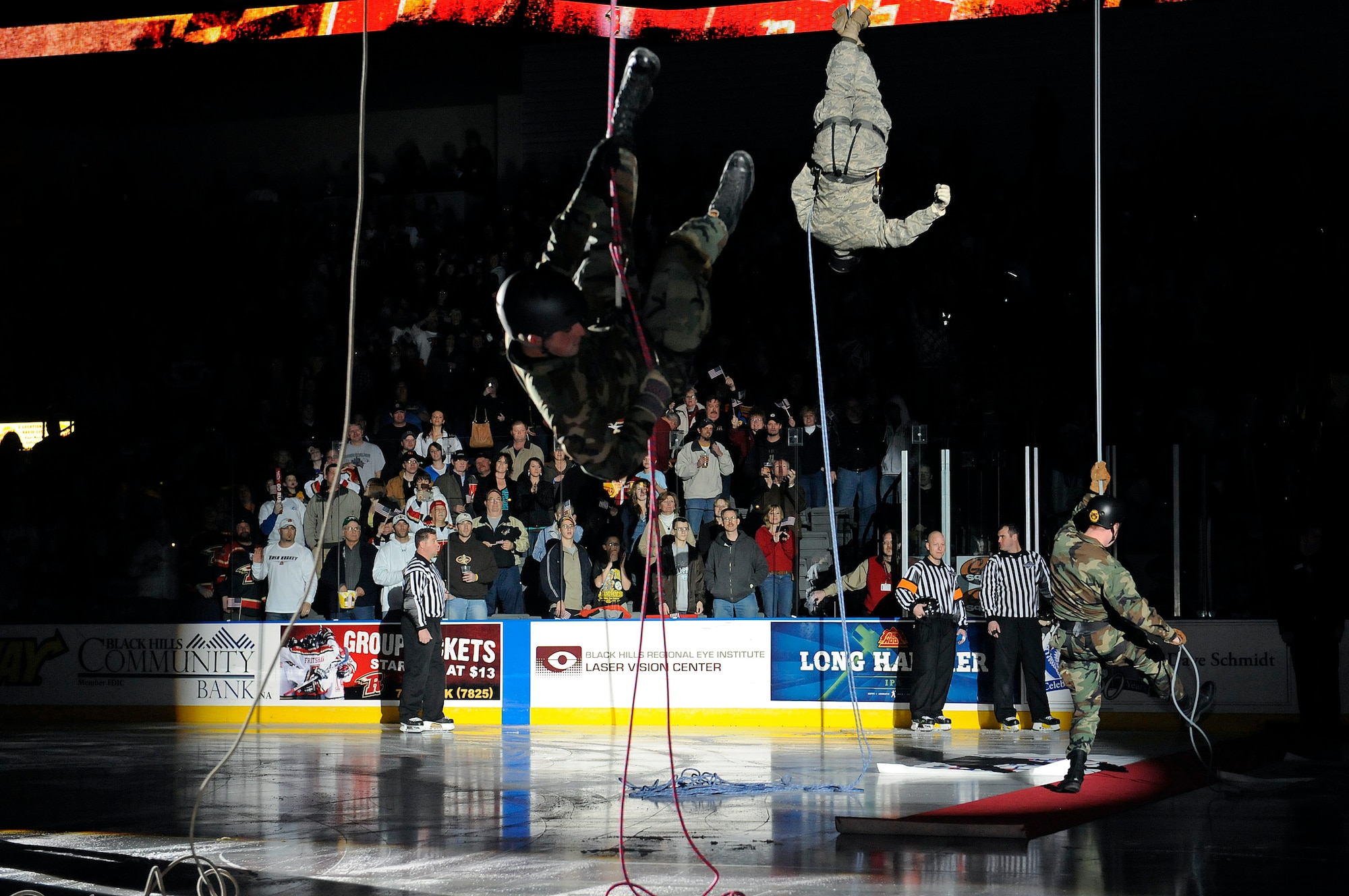 Company grade officers from Ellsworth repel onto the ice from the rafters at a Rapid City Rush game at the Rushmore Plaza Civic Center Feb. 28. More than 5,000 fans attended the Military Appreciation Night hockey game. (US Air Force photo/Airman 1st Class Corey Hook)