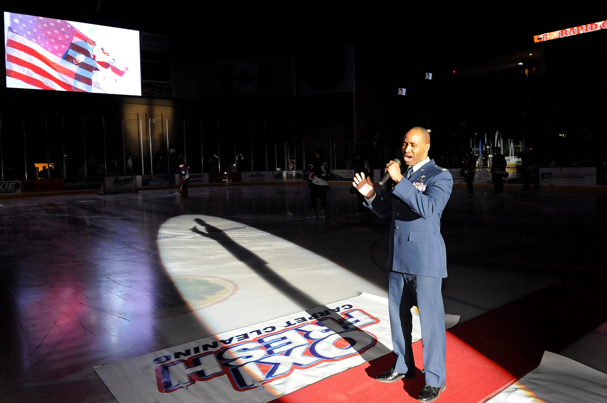 Maj. Michael Edwards, 28th Maintenance Operations Squadron commander, sings the National Anthem before a Rapid City Rush hockey game at the Rushmore Plaza Civic Center Feb. 28. The Wichita Thunder defeated the Rush 3-2 during Military Appreciation Night honoring past and present servicemembers. (US Air Force photo/Airman 1st Class Corey Hook)
