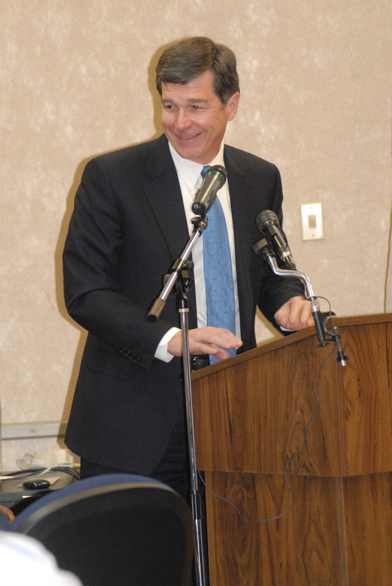 North Carolina Attorney General Roy Cooper prepares to speak to Pope Airmen to kickoff Military Saves Week here Feb. 23. (U.S. Air Force Photo by Airman 1st Class Mindy Bloem)
