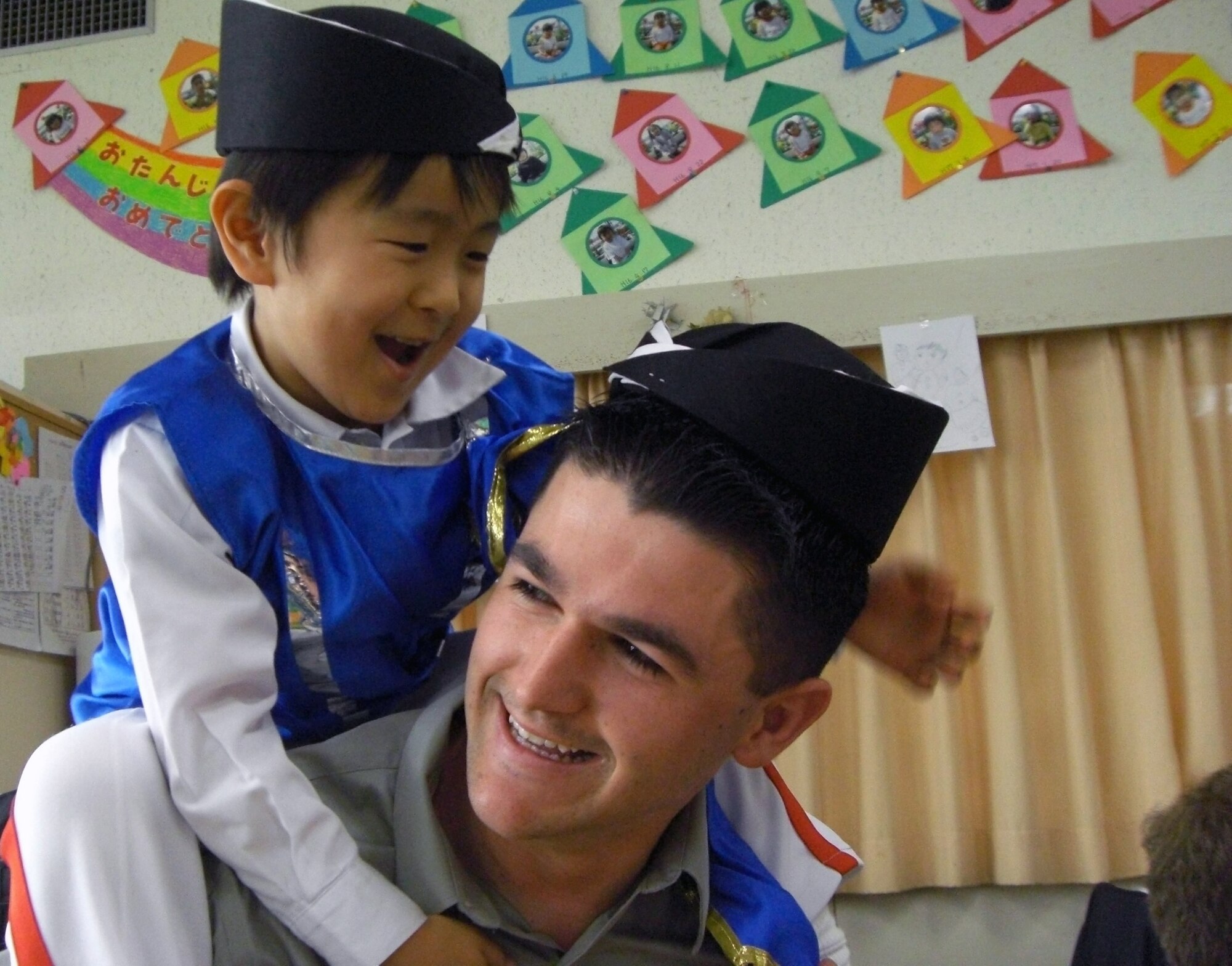 Airman 1st Class Jacob Davidson plays with a child from the Isshin Preschool Feb. 26 in Miyazaki Prefecture, Japan. Airmen from Kadena Air Base, Japan, volunteered to teach English skills at the preschool during a week-long bilateral training event with the Japan Air Self Defense Force at Nyutabaru Air Base. Airman Davidson is assigned to the from the 18th Communication Squadron. (Courtesy photo) 
