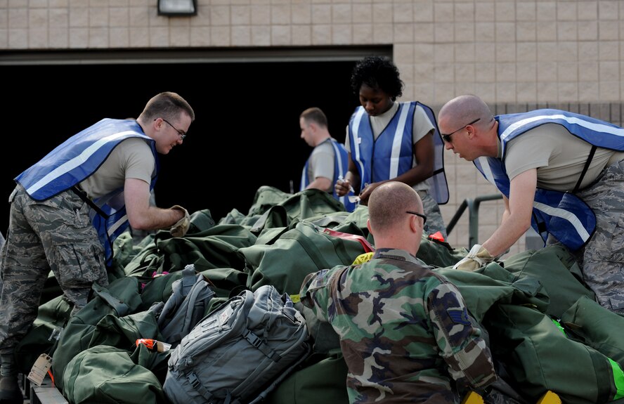 MOODY AIR FORCE BASE, Ga. -- (Bottom) Staff Sgt. Joe Stanchak, 23rd Logistics Readiness Squadron, air transportation instructor, supervises augmentees as they load mobility bags onto a New Generation Small Loader before they are uploaded to a McDonnell Douglas MD-11 aircraft in support of a deployment here Feb. 26. Members from the 23rd LRS provide crucial support during deployments and redeployments at Moody. (U.S. Air Force photo by Senior Airman Gina Chiaverotti)