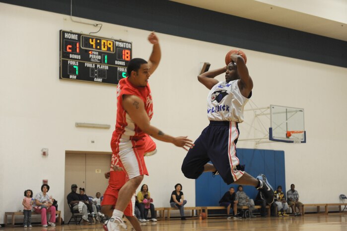 NELLIS AIR FORCE BASE, Nev. -- Staff Sgt. Greg Dailey, from the 99th Civil Engineering Squadron, jumps to make a pass over a forward from the Medical Group team during the championship game of the 2009 Nellis Fitness Intramural Basketball Tournament Feb. 27. CES beat MDG to become the 2009 intramural basketball champions.(U.S. Air Force photo by Airman 1st Class Bret Clashman)