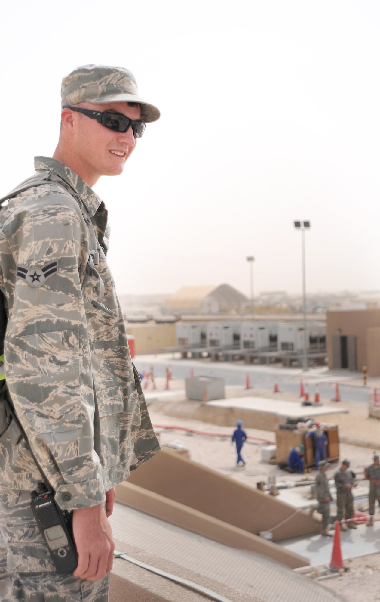 Airman 1st Class Luke Hoyt performs an overwatch of off-base contract workers ensuring the security of the area and the safety of servicemembers Feb. 23 at an air base in Southwest Asia. Airman Hoyt is a 379th Expeditionary Civil Engineer Squadron third country national escort. He hails from Dubuque, Iowa, and is deployed from Spangdahlem Air Base, Germany. (U.S. Air Force photo/Airman 1st Class Andrew Satran) 

